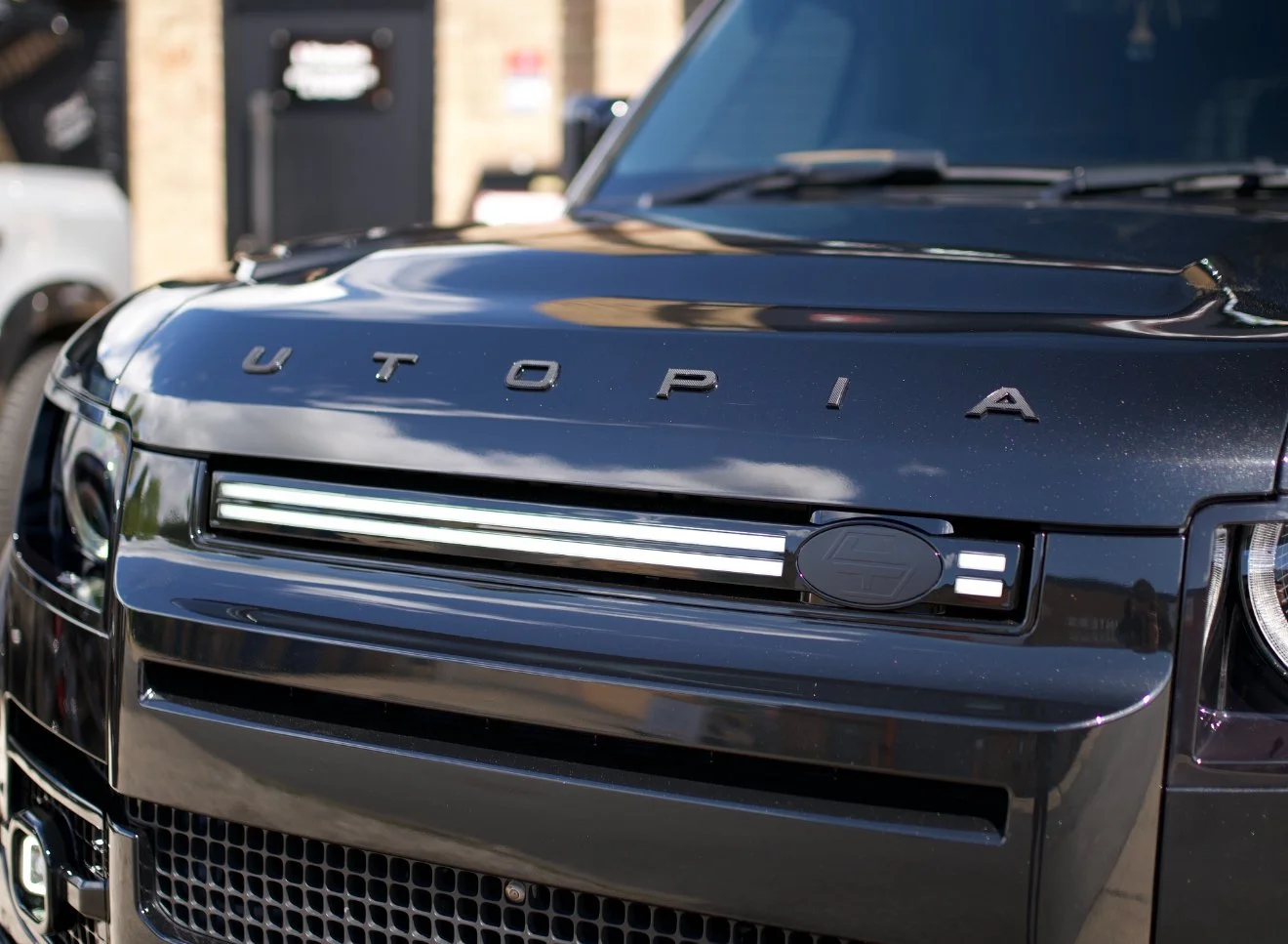 LED front grille light DRL fitted to the grille of a black Land Rover Defender