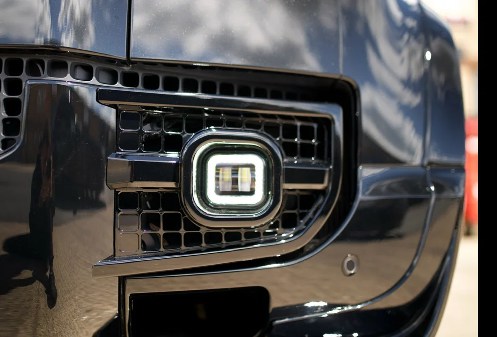 Gloss black vented Defender fog lights with square DRL