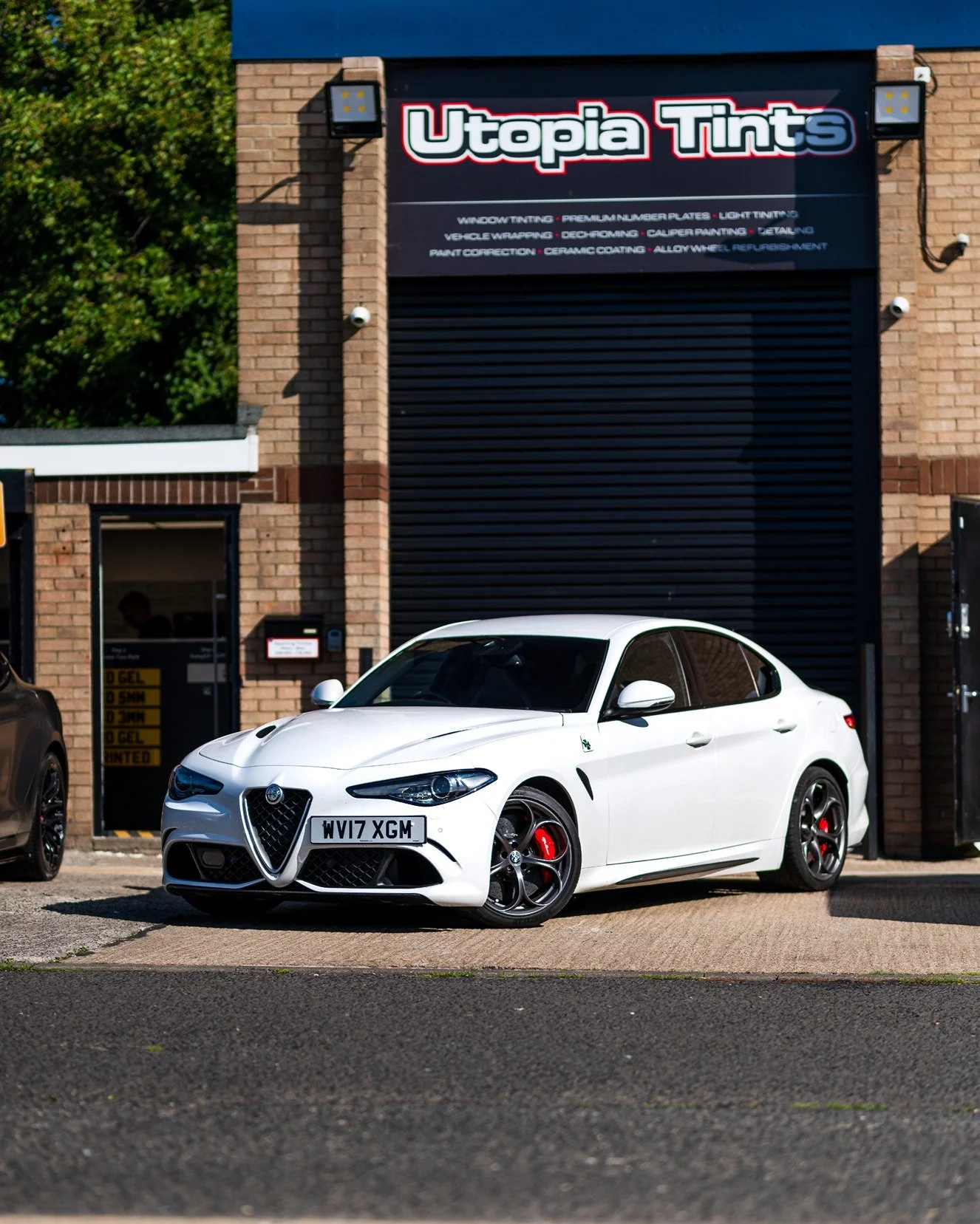 Freshly painted brake calipers on a car at the Utopia workshop in Durham