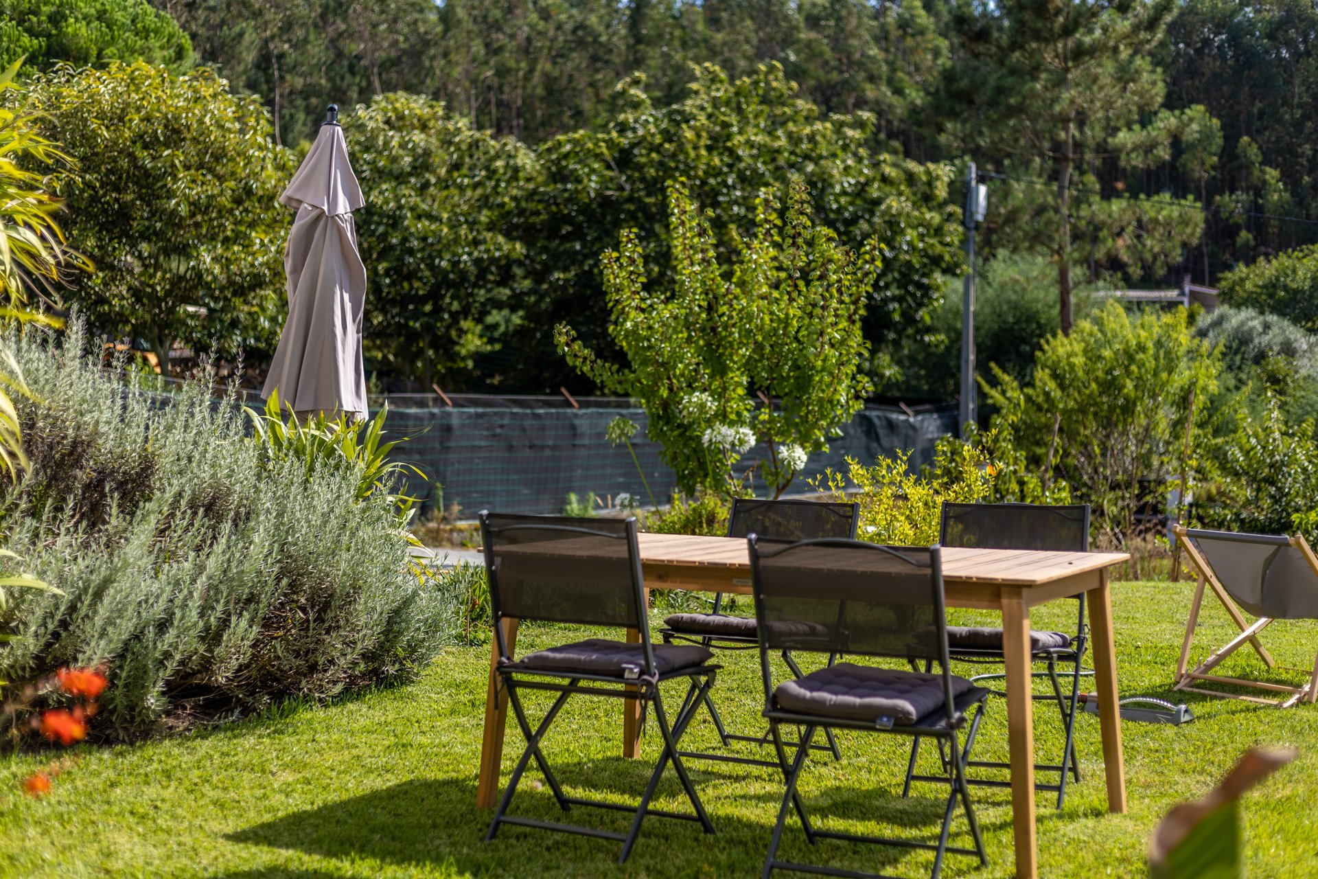 Villa Nour, Leiria, Portugal, back garden exterior garden dining table with cantilever garden parasol
