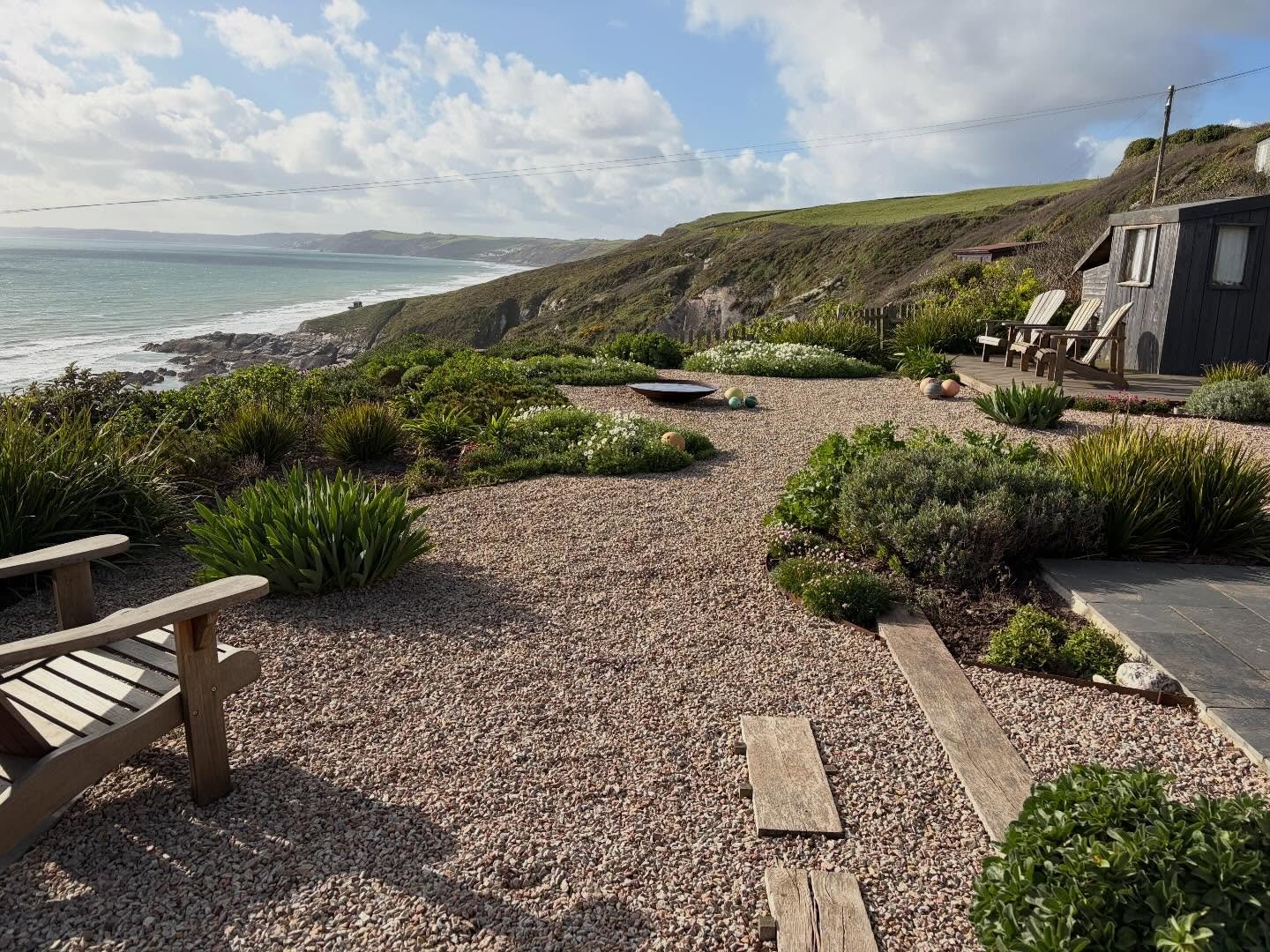 A simple coastal gravel garden made using natural and reclaimed materials plus flotsam and jetsam collected by our clients. All the team love working here (although access down the cliff isn&rsquo;t easy!!) Photos from last week (yes that is the sun!
