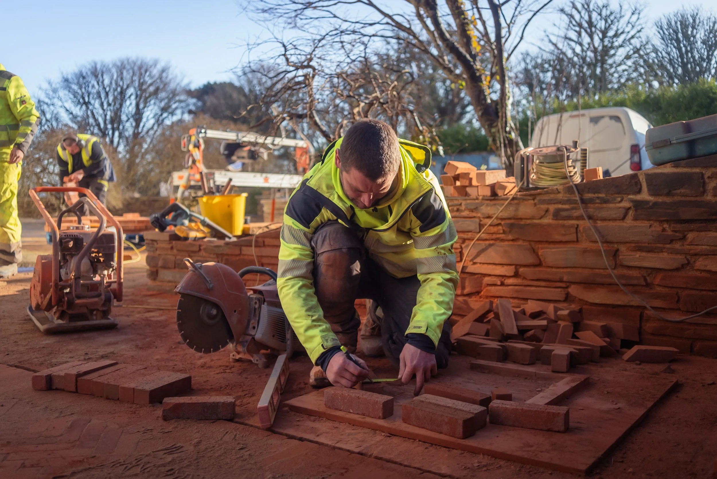Worker from James & Co Landscapes laying bricks for a garden path in St Ives.