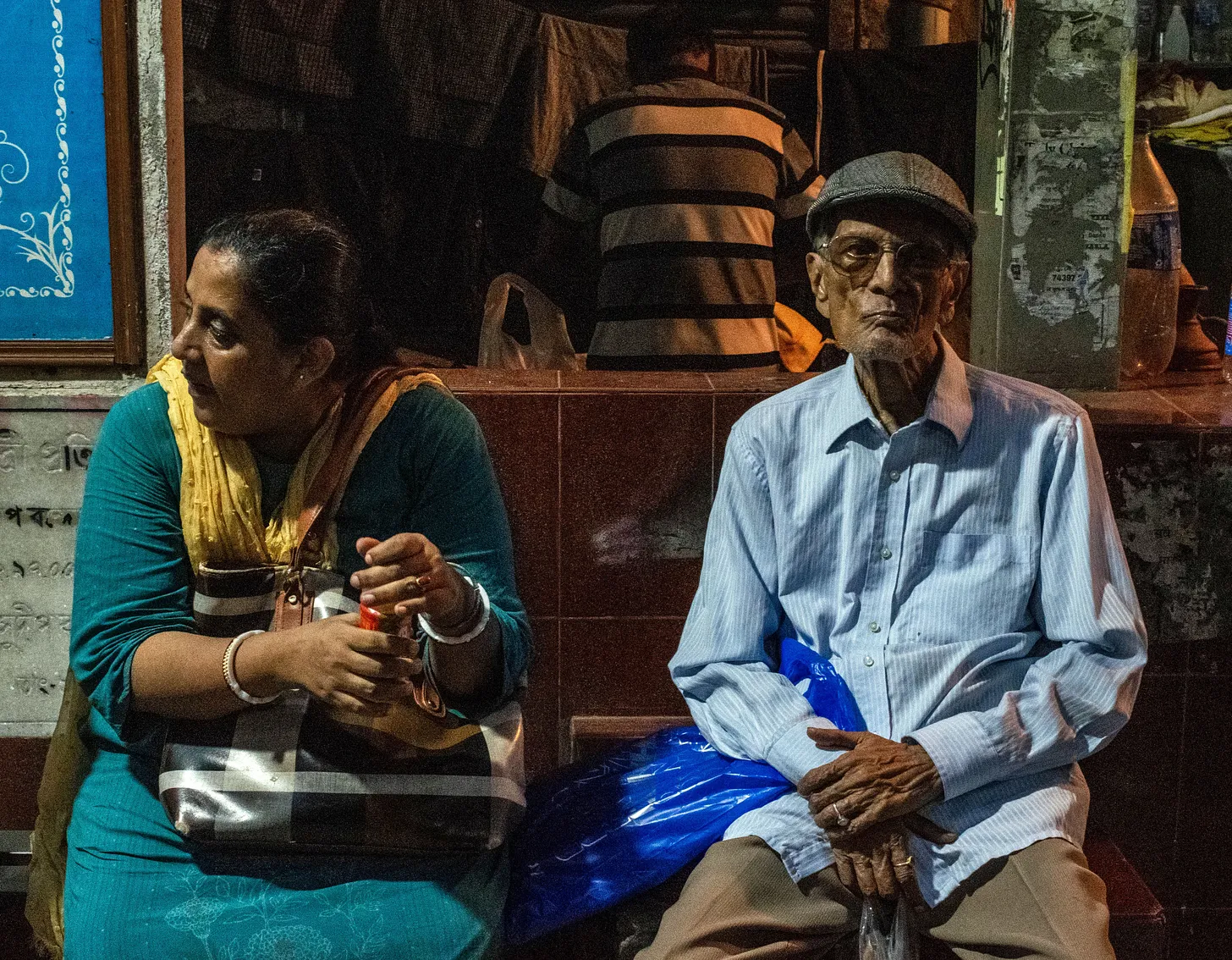 Couple waiting for the bus in early evening