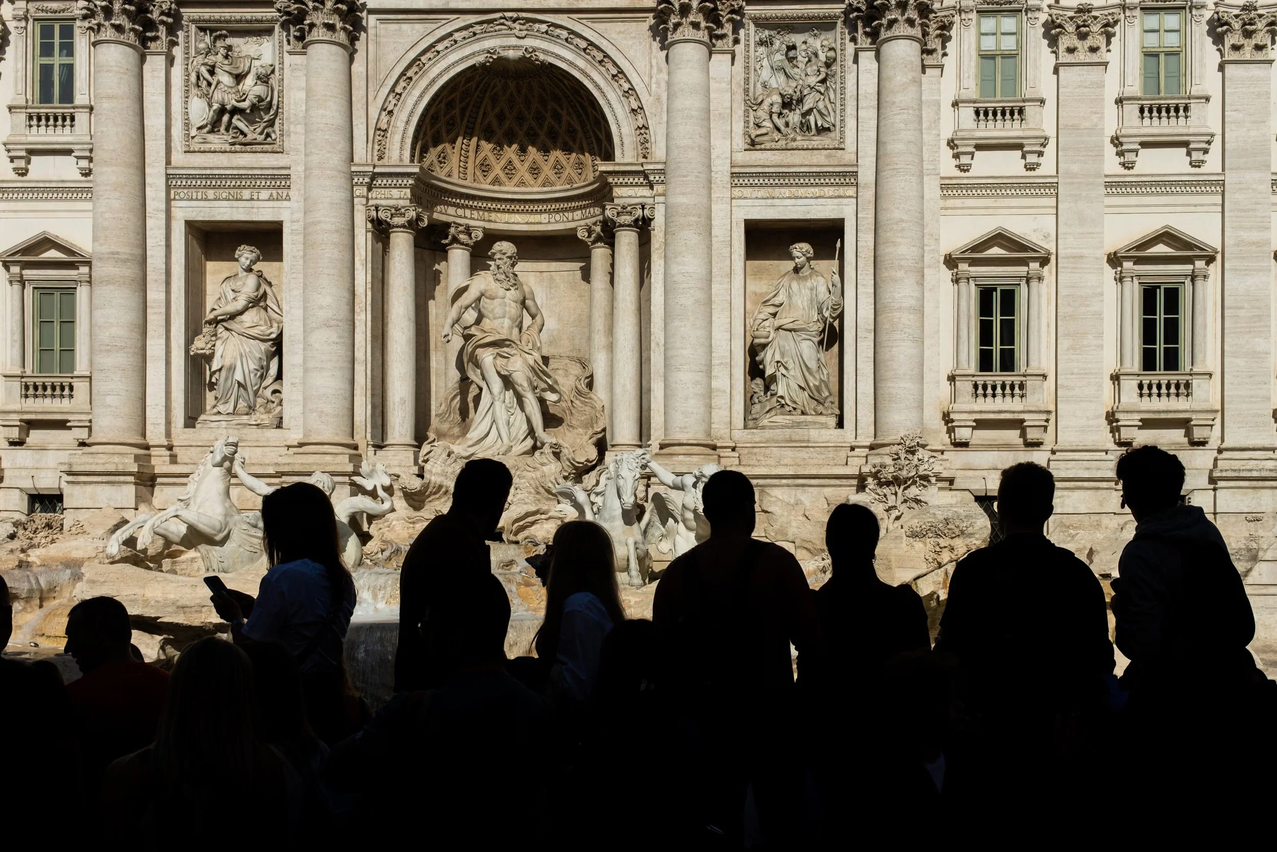 Visitors gather in front of the Trevi Fountain