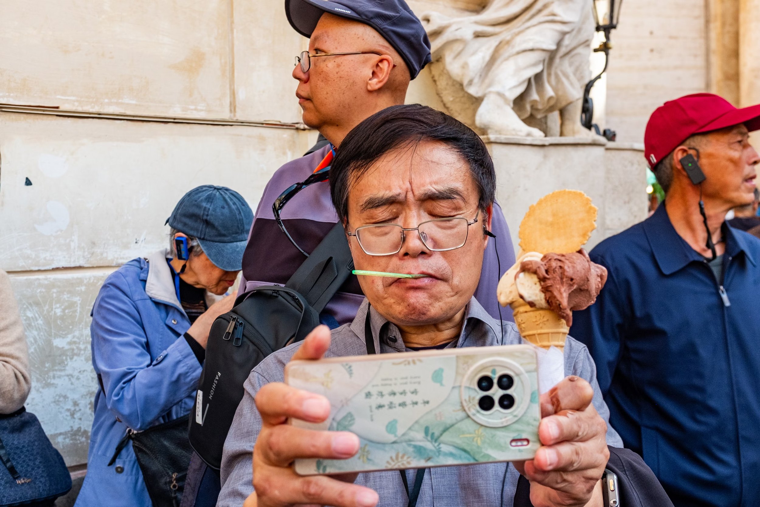 A tourist takes a selfie while eating an ice-cream near the Trevi Fountain