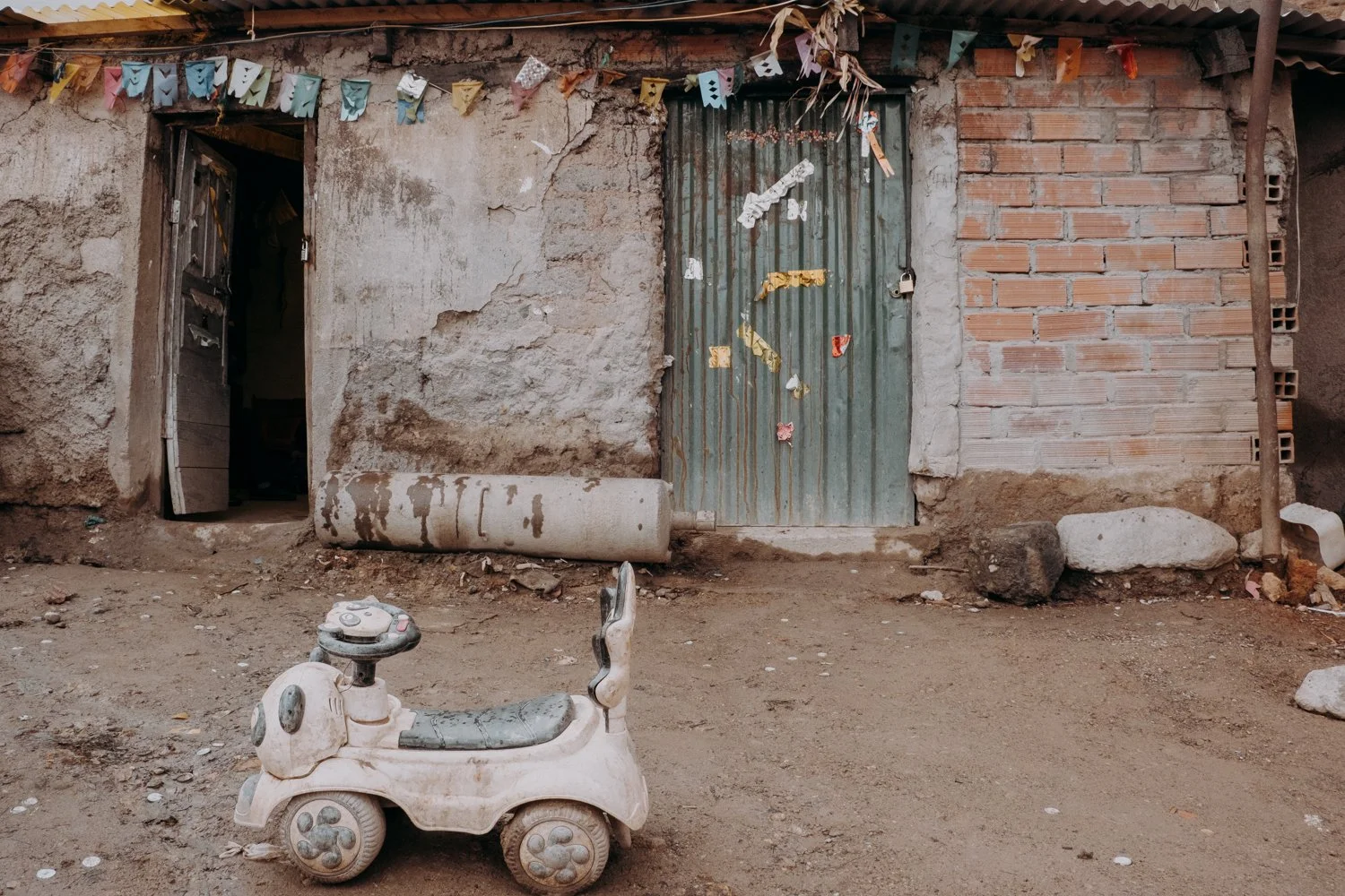Outside the entrances to the tunnels, miners' children grow up