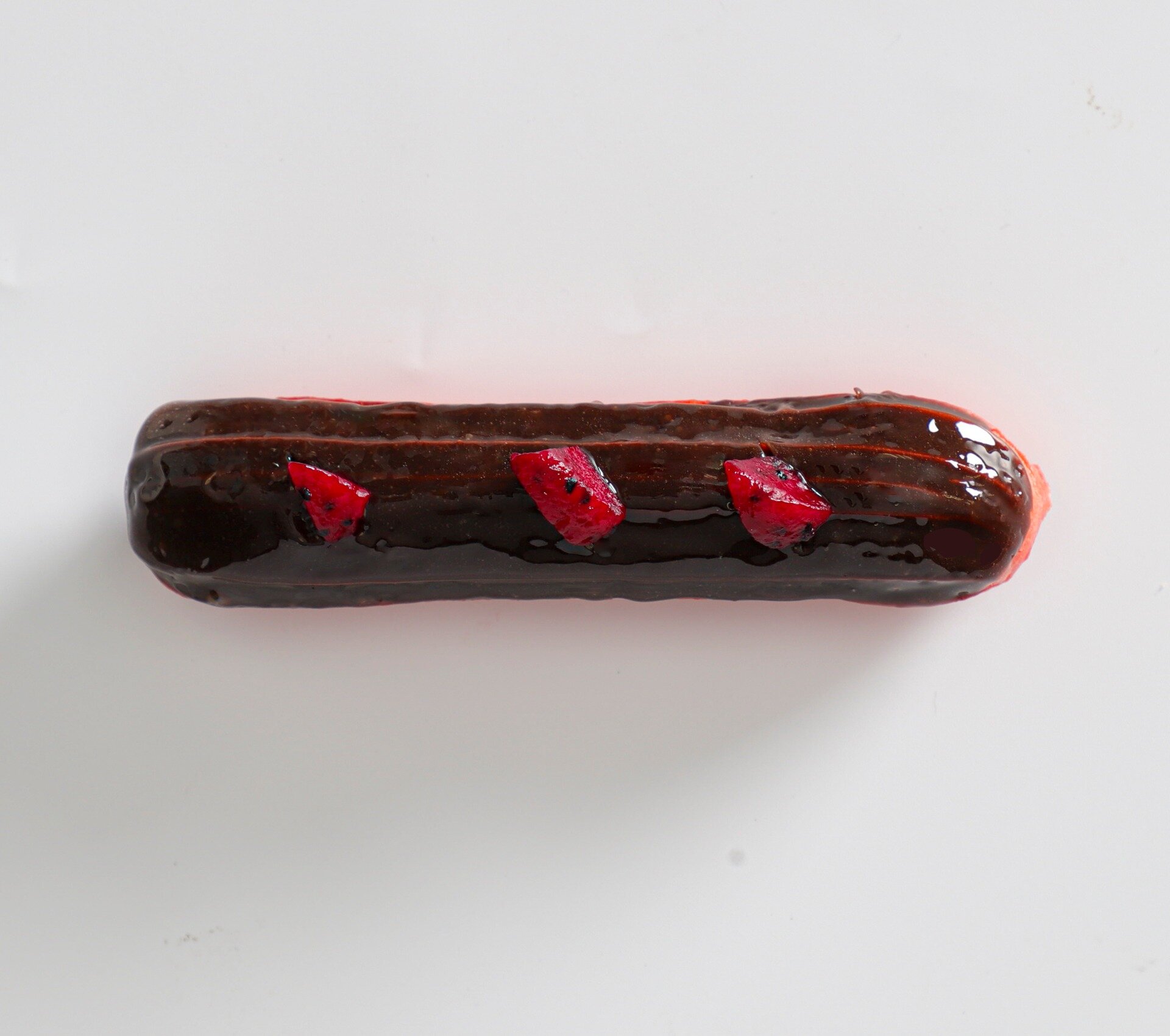 Magenta Dragon Eclair
Filled with smooth vanilla cream and topped with a deliciously decadent dark chocolate glaze and small slices of dragon fruit. Pro tip: you can alternate between white and pink varieties of the fruit to add a stunning contrast.
