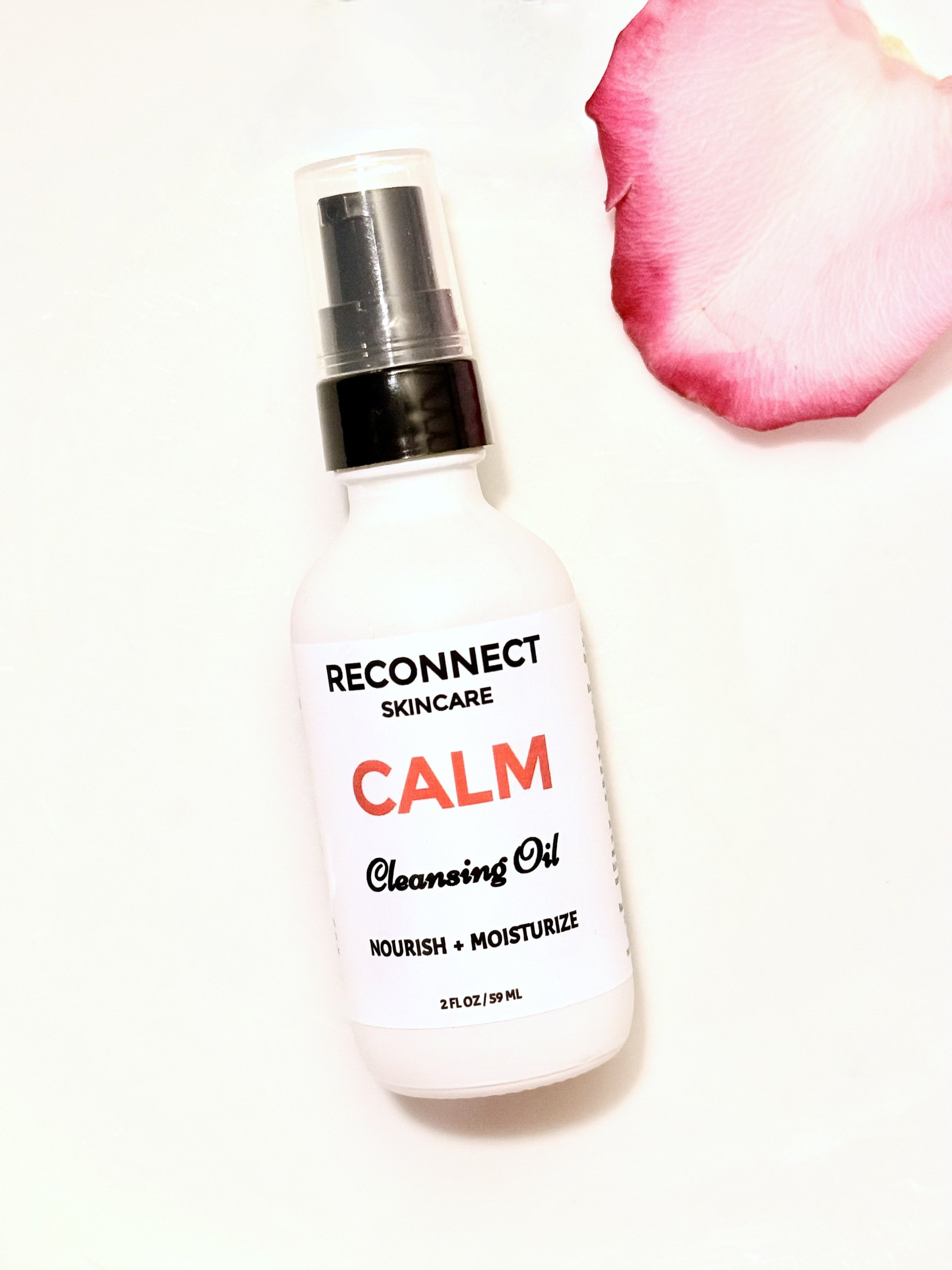 ALM Cleansing Oil elegantly displayed with soft rose petal, highlighting its soothing and gentle formulation.