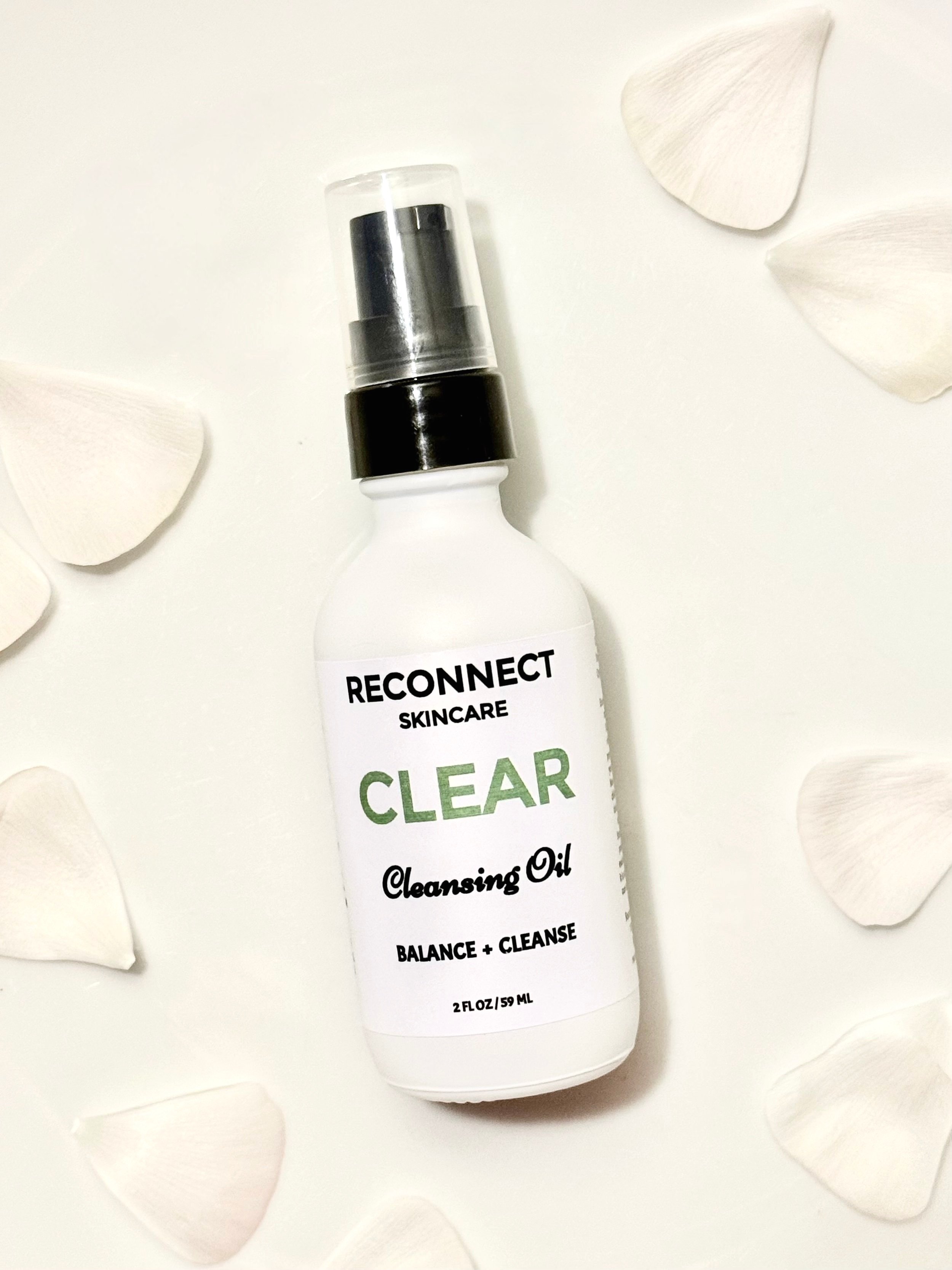 CLEAR Cleansing Oil elegantly displayed against a soft petal background, highlighting its gentle and nourishing formula.