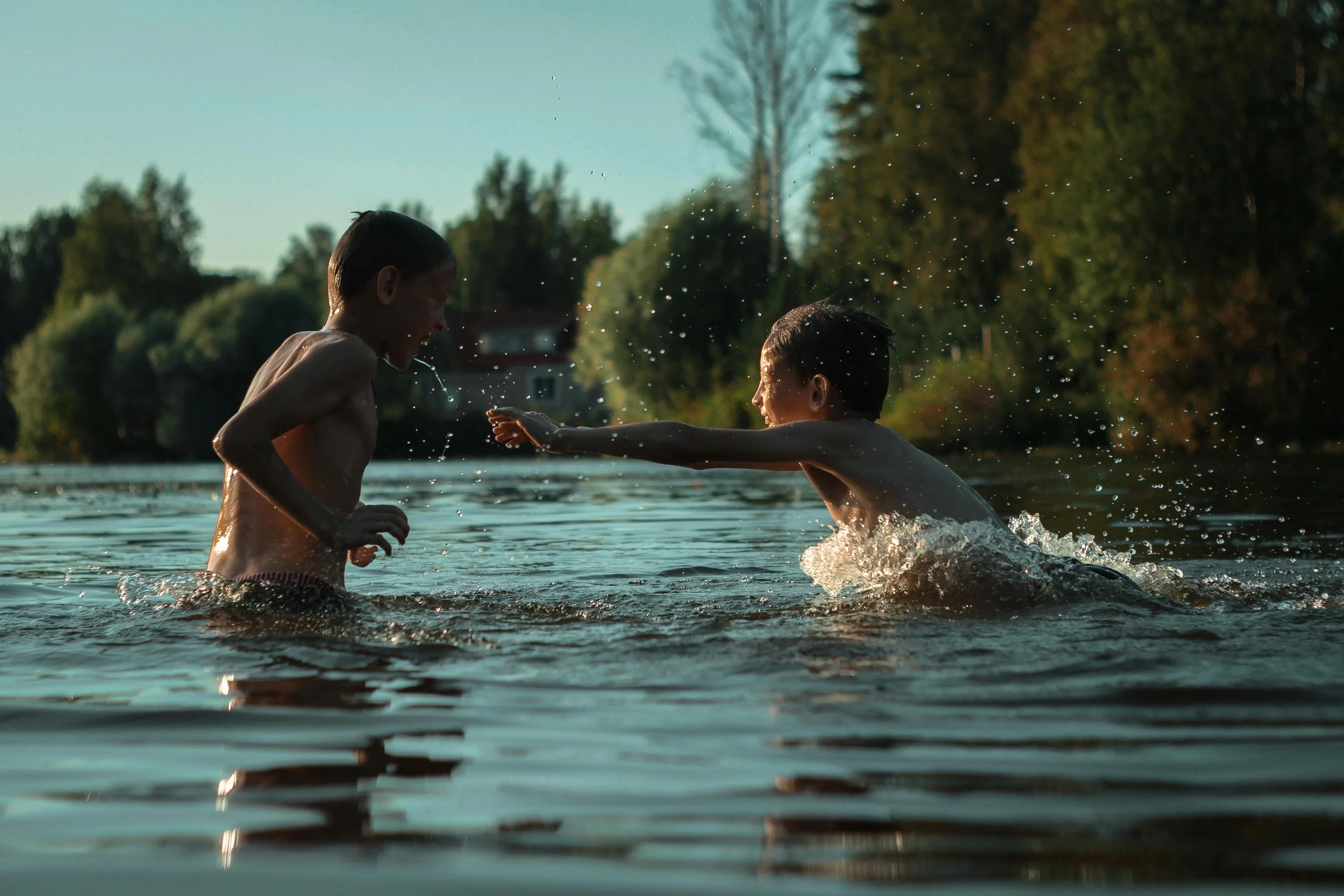 Kids having fun in the summer playing in water | Therapy for anxious kids helps them enjoy life