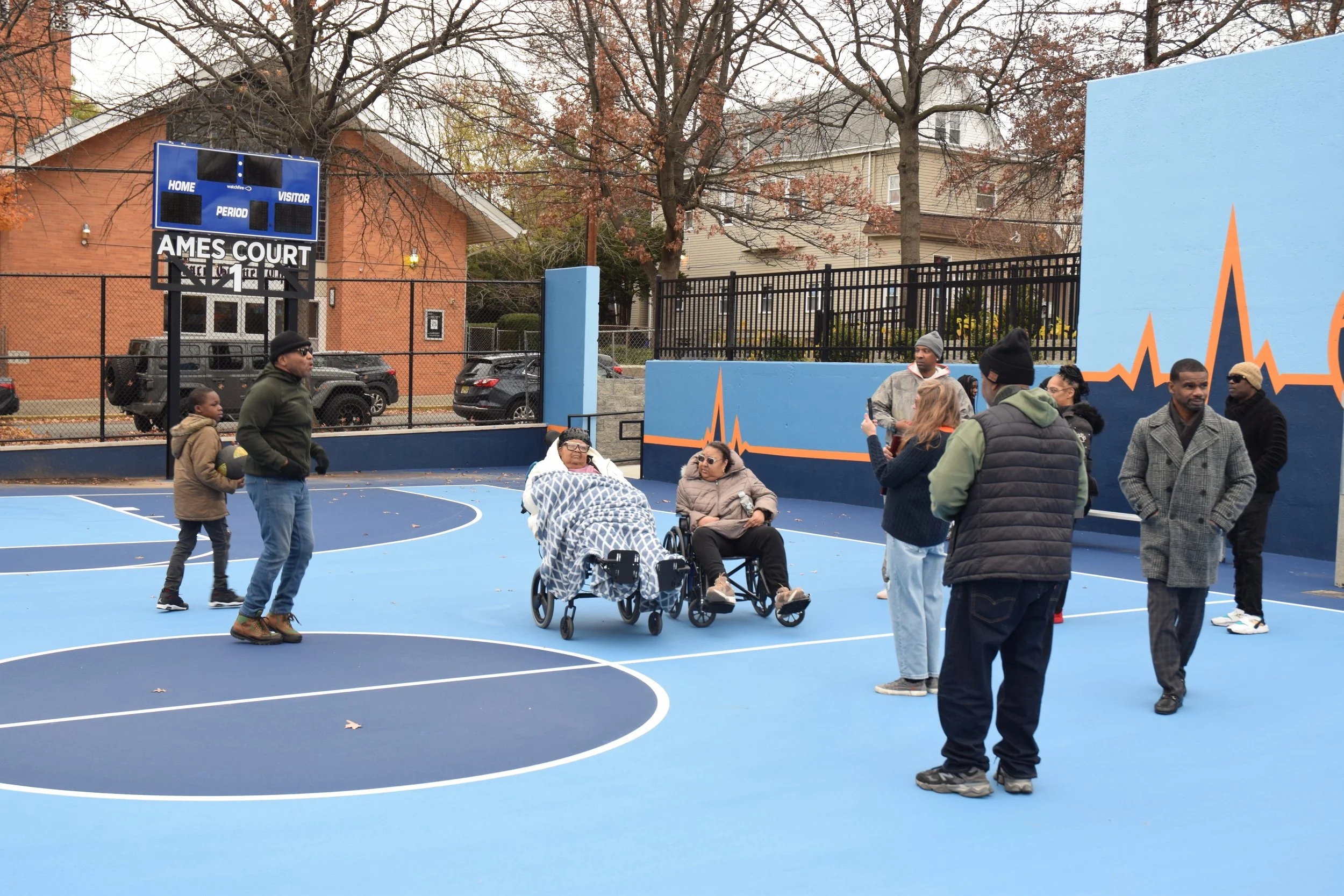 Newly resurfaced basketball courts with scoreboards