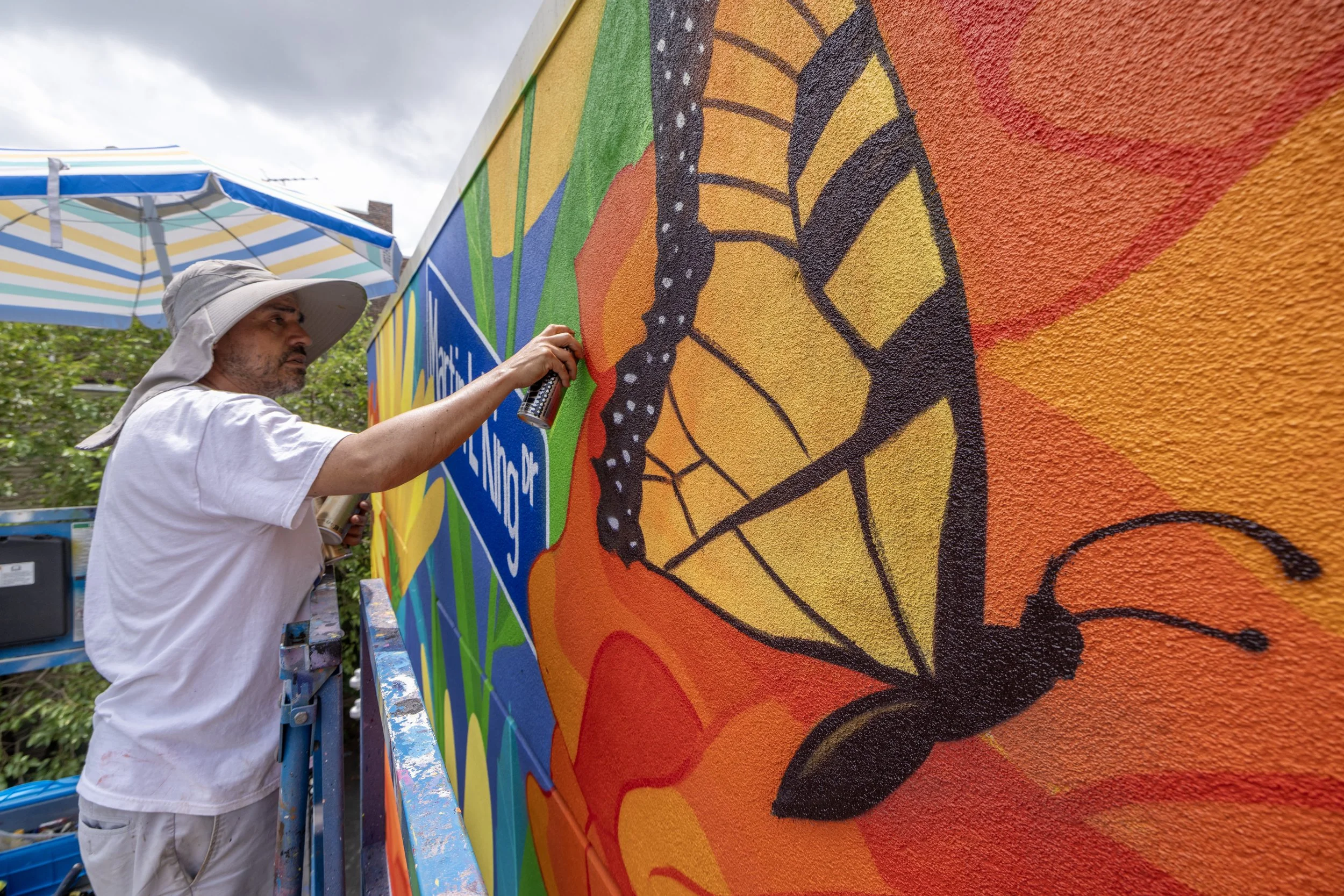 Artist El Cekis at work on new mural. Photo by Jennifer Brown.