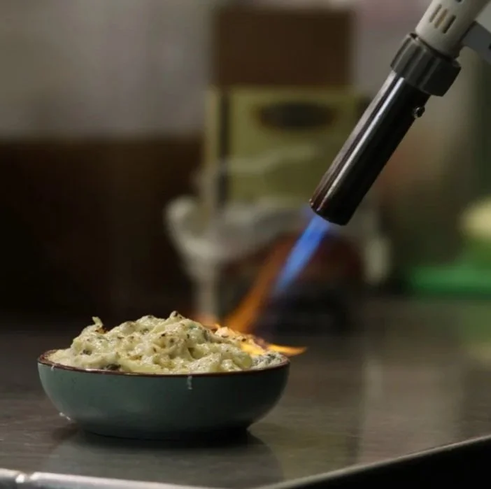 Prepping a dish for a wedding tasting.