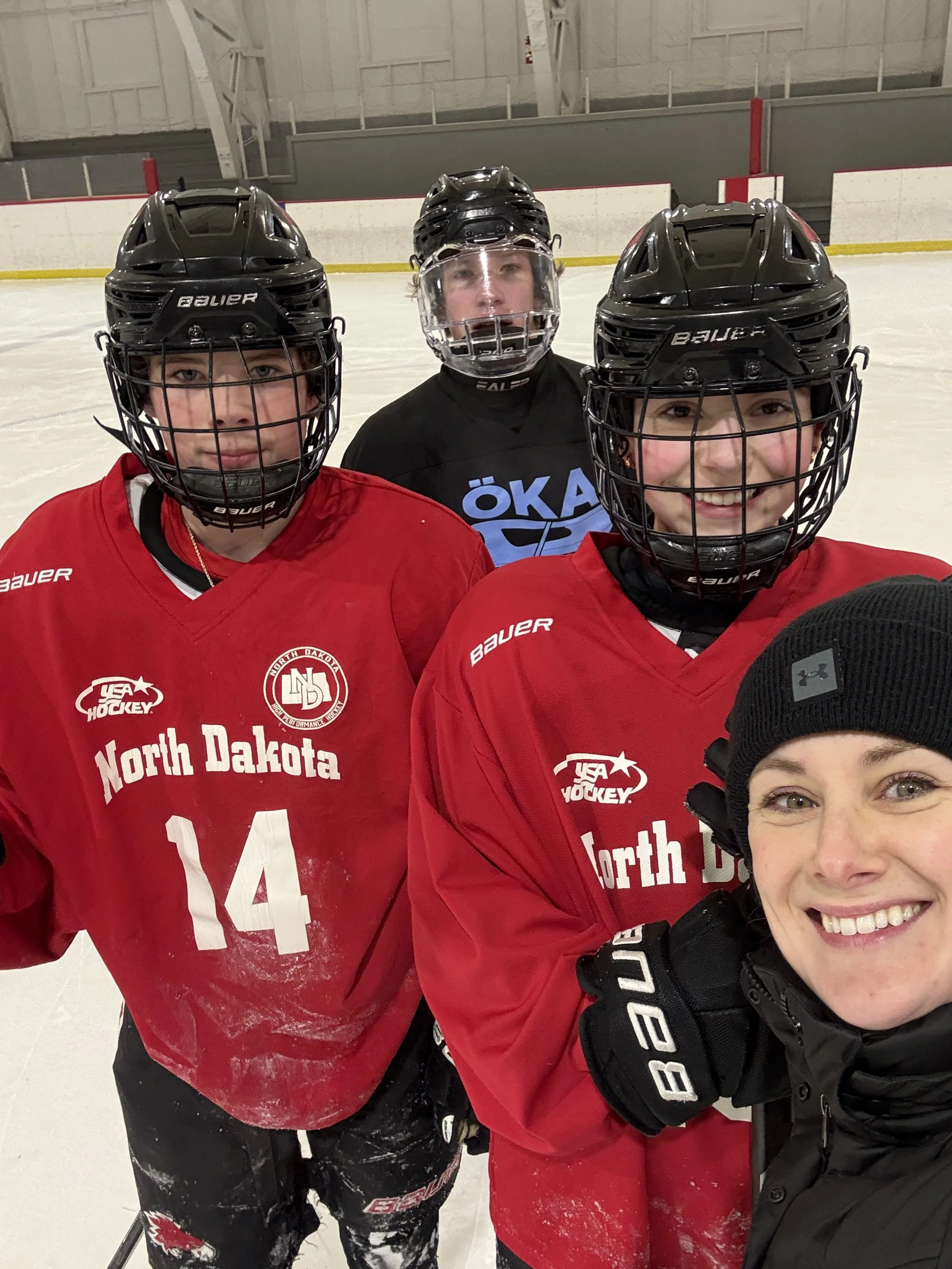 hockey players smiling with their coach