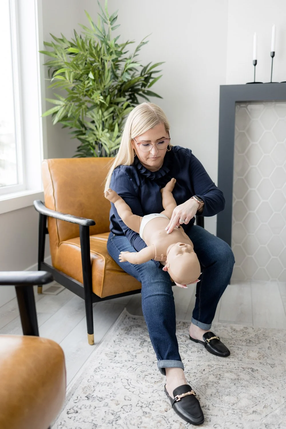 Theresa demonstrating infant choking first aid technique during a CPR and first aid training class.