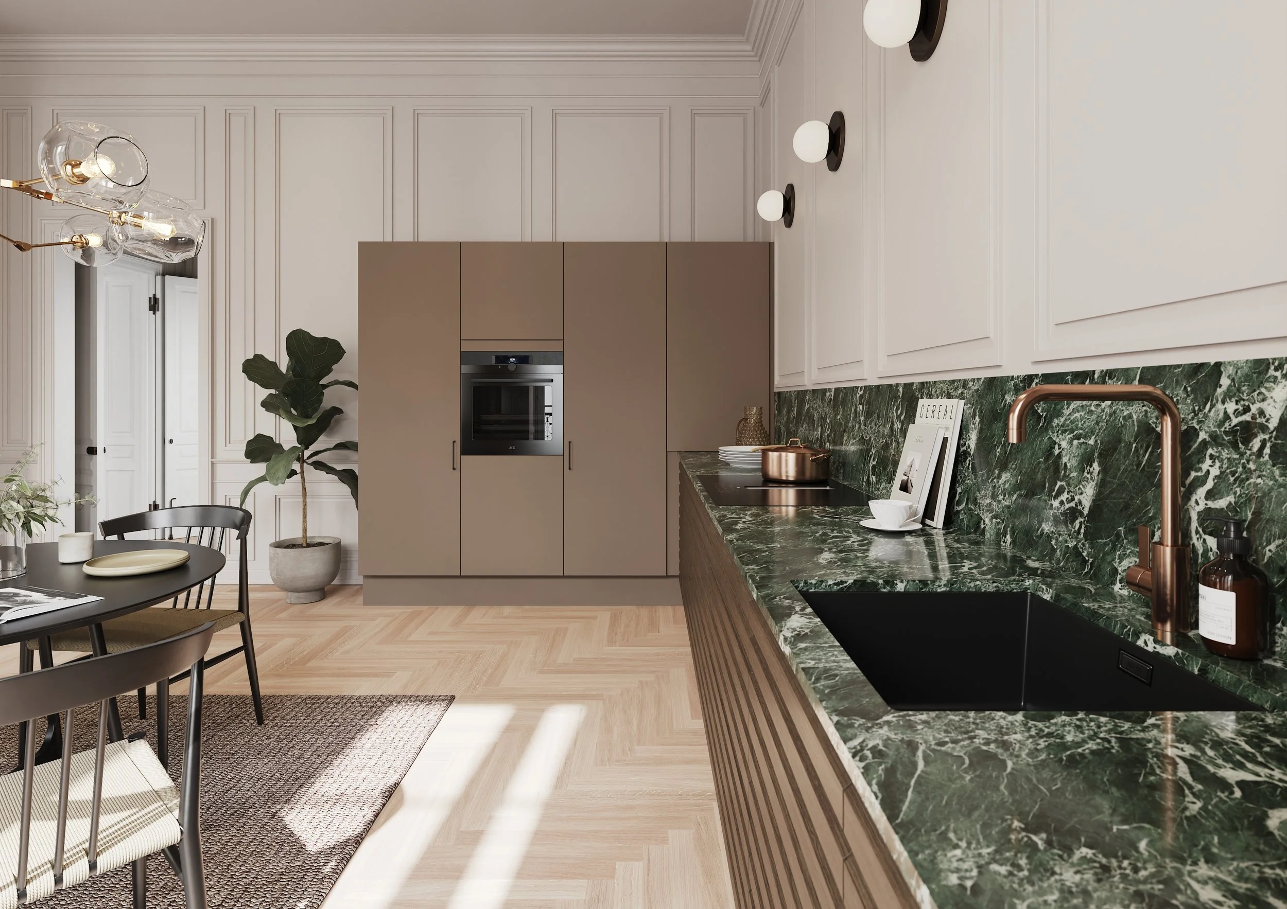 Modern kitchen with white paneled walls, beige cabinets, green marble countertops and backsplash, black sink, copper faucet, and copper cookware. A dining table with black chairs and a rug are nearby, with a large potted plant in the corner.