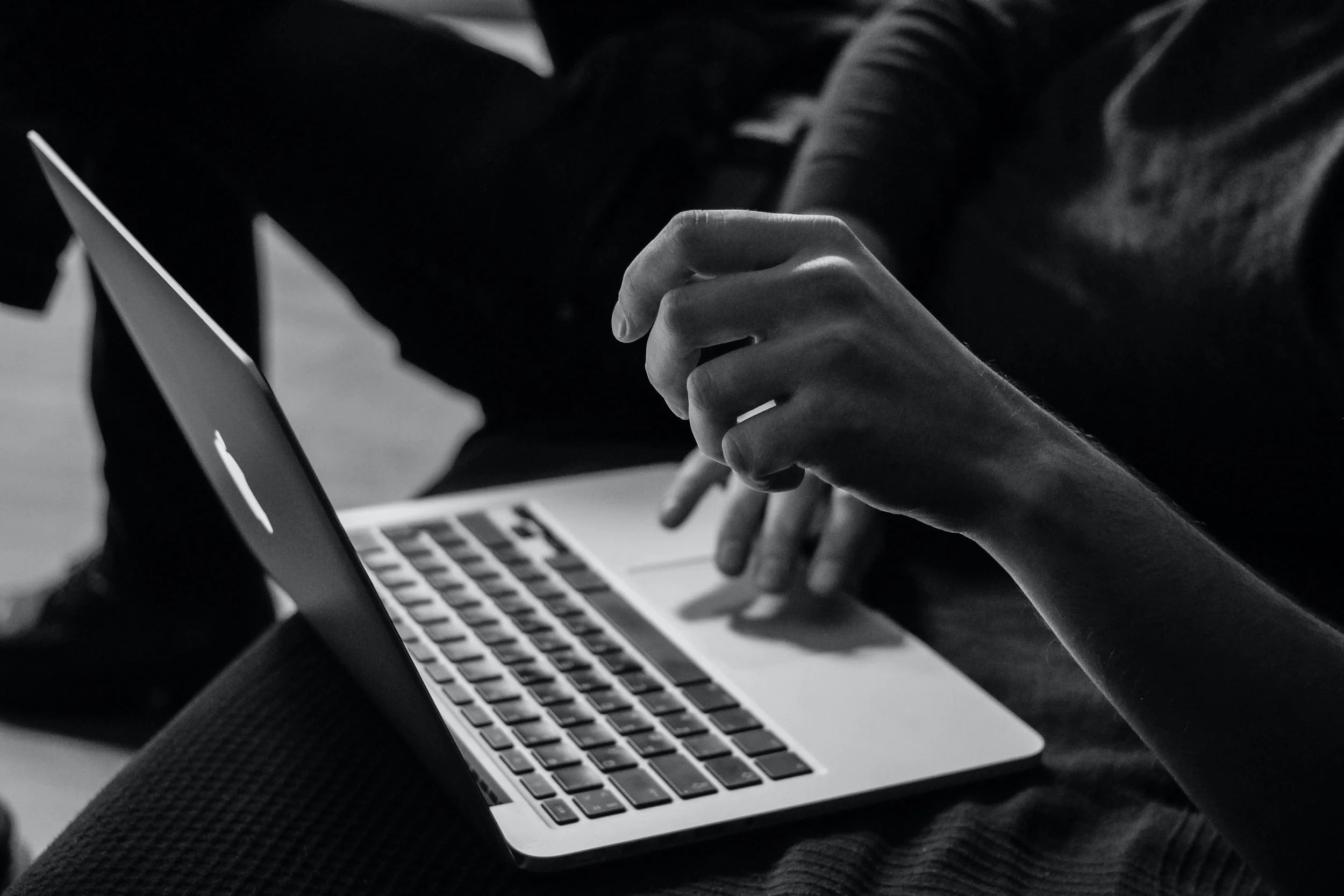 Hands typing on a laptop