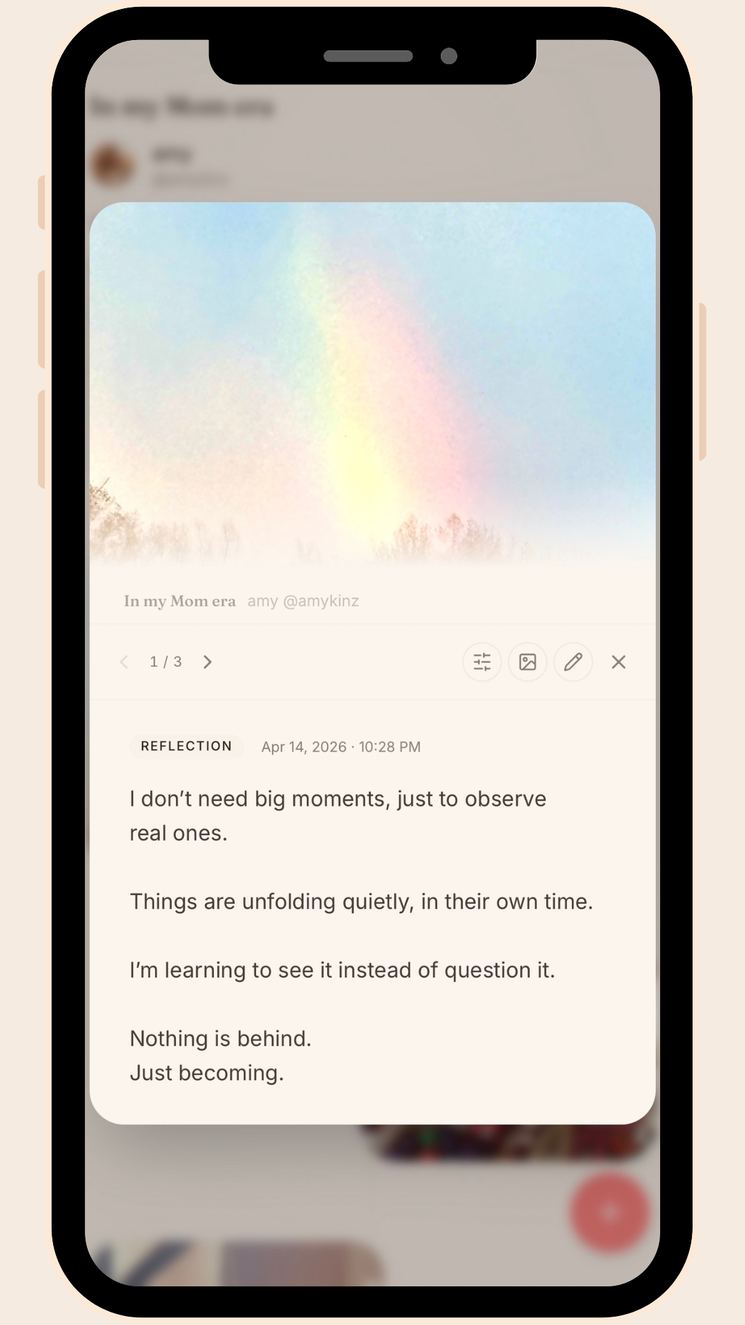 KINZ app screen showing a Living Project called "In my Mom era" with a reflection moment captured by user. Post reads: I don't need big moments, just to observe real ones. A soft rainbow sky image sits above the reflection entry dated April 14,2026