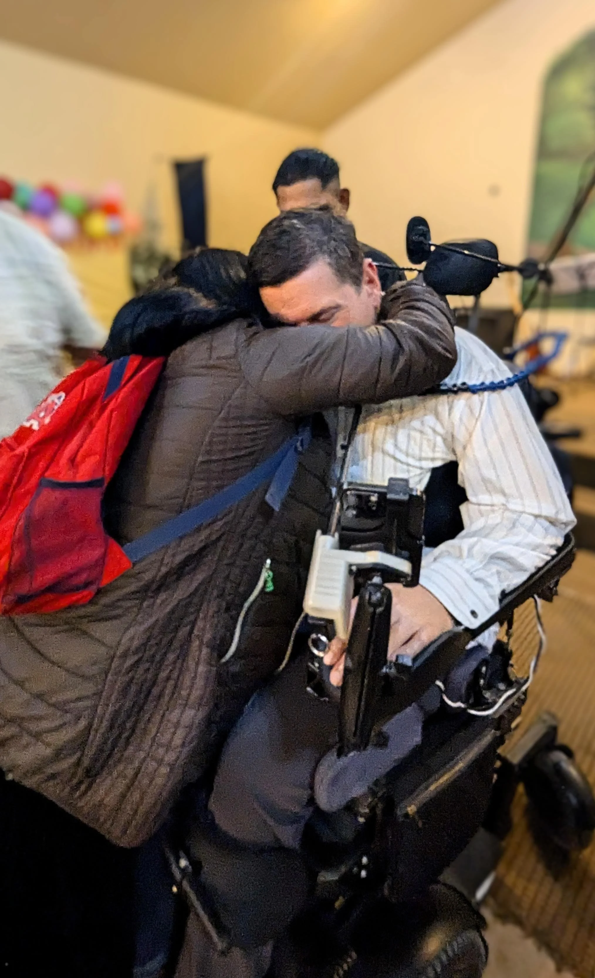 Wes receives a hug after speaking. After each talk they opened it up for questions and someone in the audience asked what Wes missed most since being paralyzed. He answered, "I miss hugging people." This lady was compelled to go hug Wes after the ser