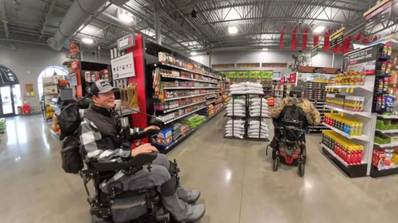 Wes Price with a new friend, Jonathan, getting hardware needed to fix broken wheelchair mount