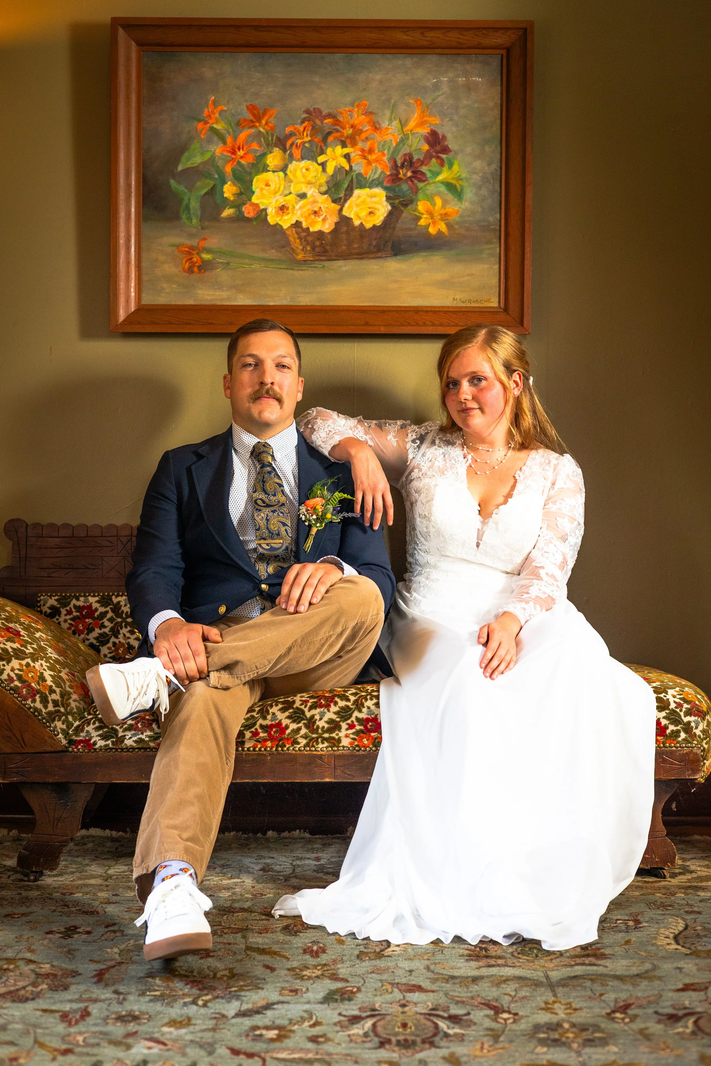 Cute wedding portrait in front of painting