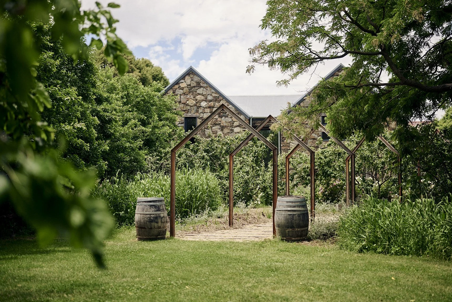 Charming stone peaks of the restaurant with lavender bushes lining a white stone path.