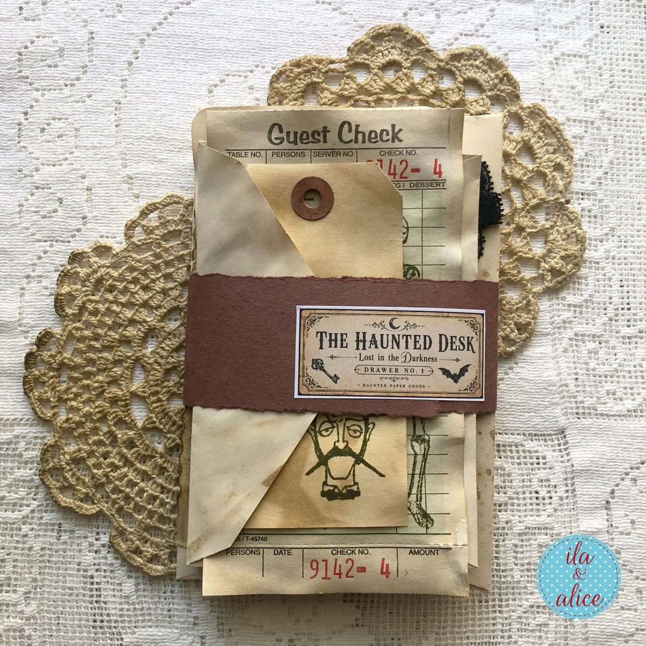 Wrapped haunted ephemera pack containing coffee-dyed envelopes, tags, guest checks and stamped papers, secured with a Lost in the Darkness: Drawer No. 1 label.