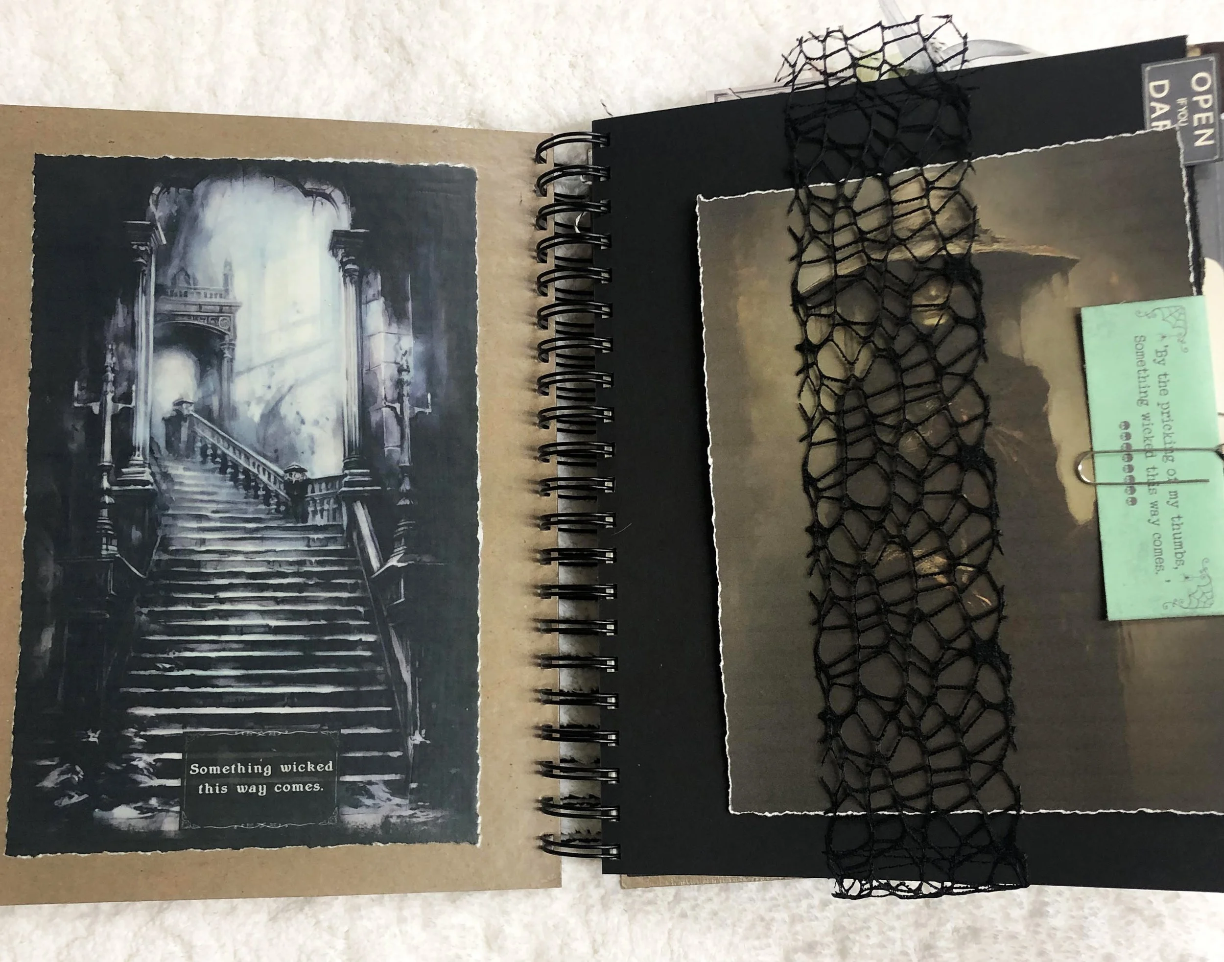 Dark witch journal spread with a haunted staircase, shadowy figure, black spiderweb lace and layered ephemera.