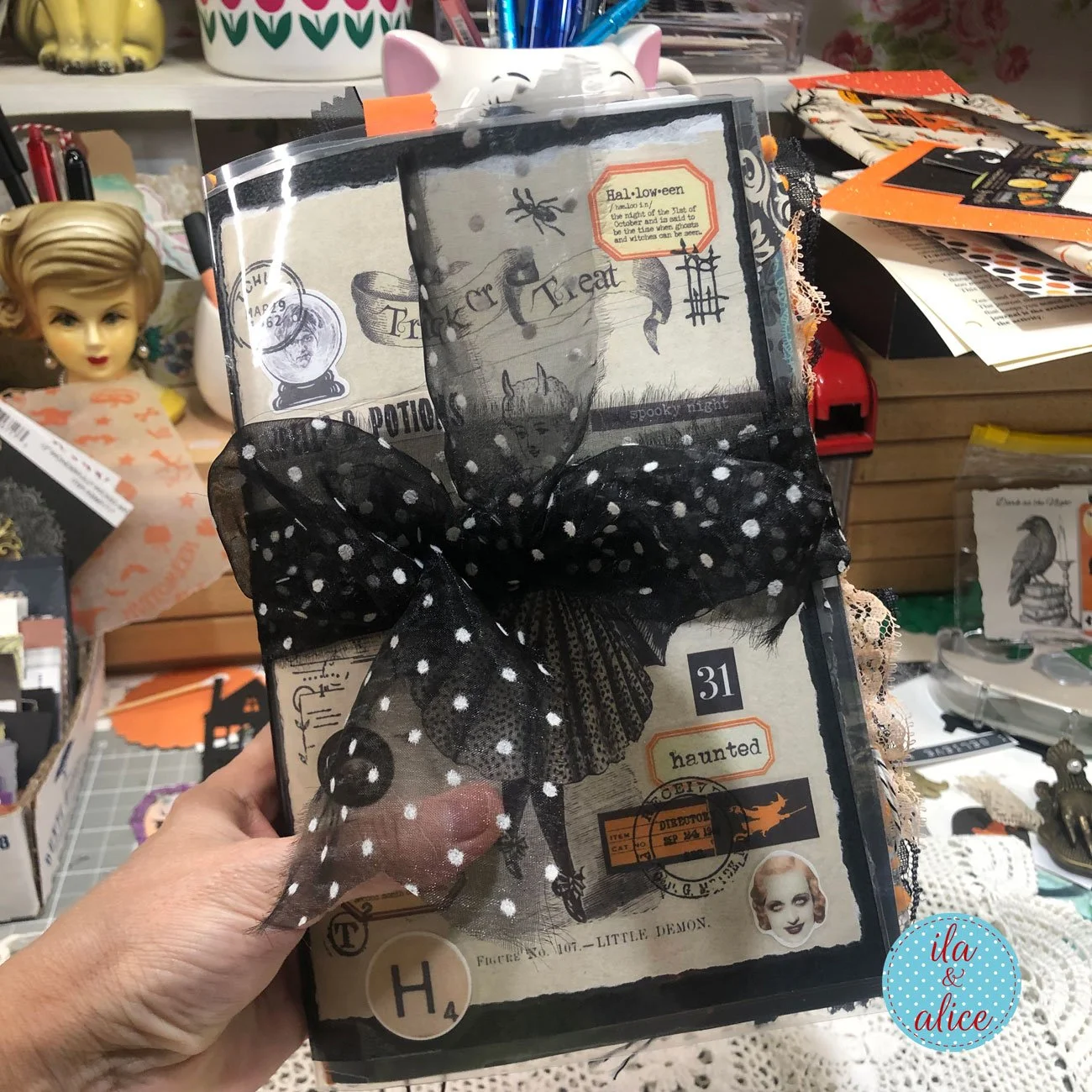 Handmade Halloween junk journal cover with vintage-style ephemera, spiders, the number 31 and an oversized black polka-dot ribbon