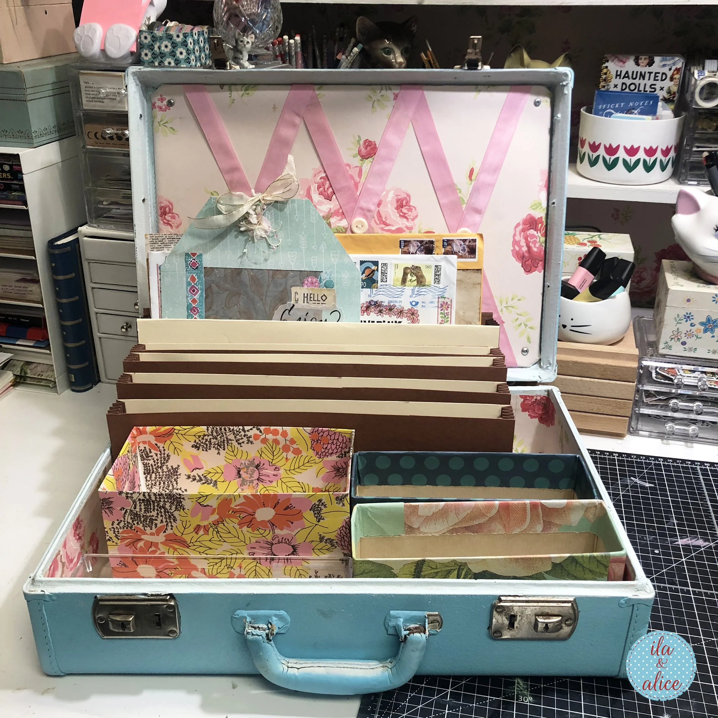 Vintage blue suitcase fitted with handmade dividers, floral boxes, and compartments for organizing happy mail, cards, tags, envelopes, and paper treasures.