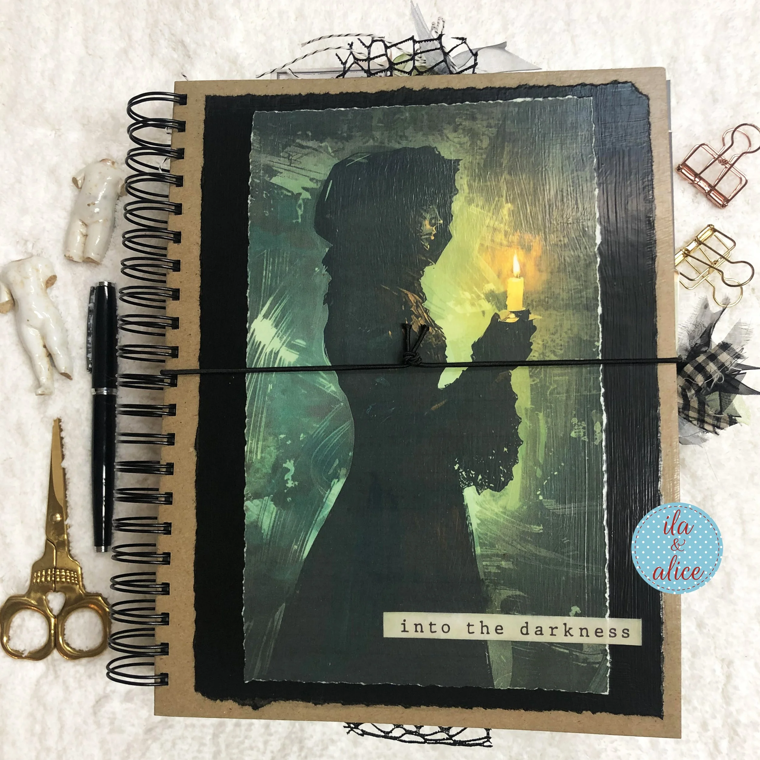 Cover of the handmade Into the Darkness witch junk journal, featuring a shadowed woman holding a candle.