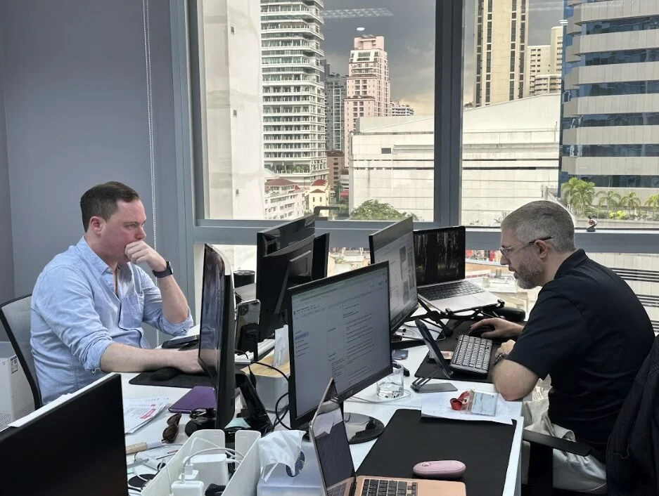 Adfinity team reviewing analytics in our Bangkok office