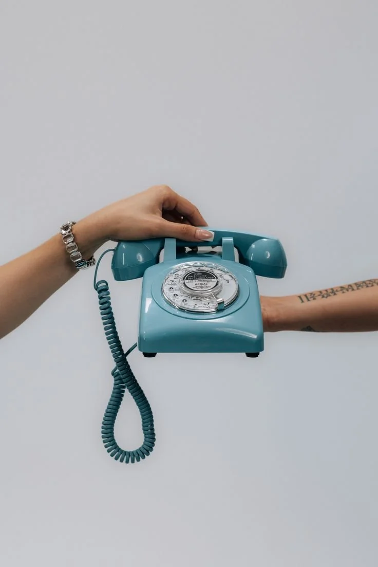 Hands holding a vintage telephone symbolising getting in touch with MMNine Lab for personal styling and image consulting enquiries