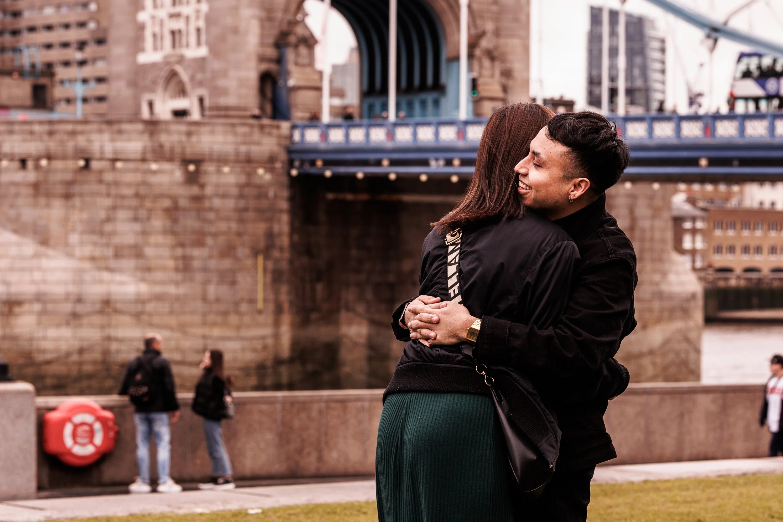 A couple hugging near Tower Bridge in London.