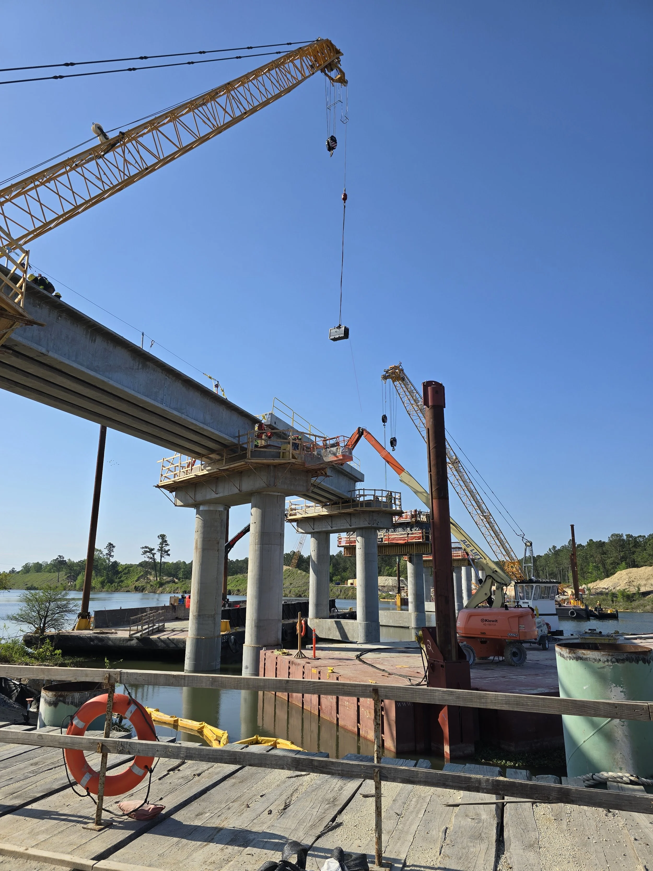 Melting Point construction crews install large structural steel components during an elevated bridge construction project completed for Kiewit.