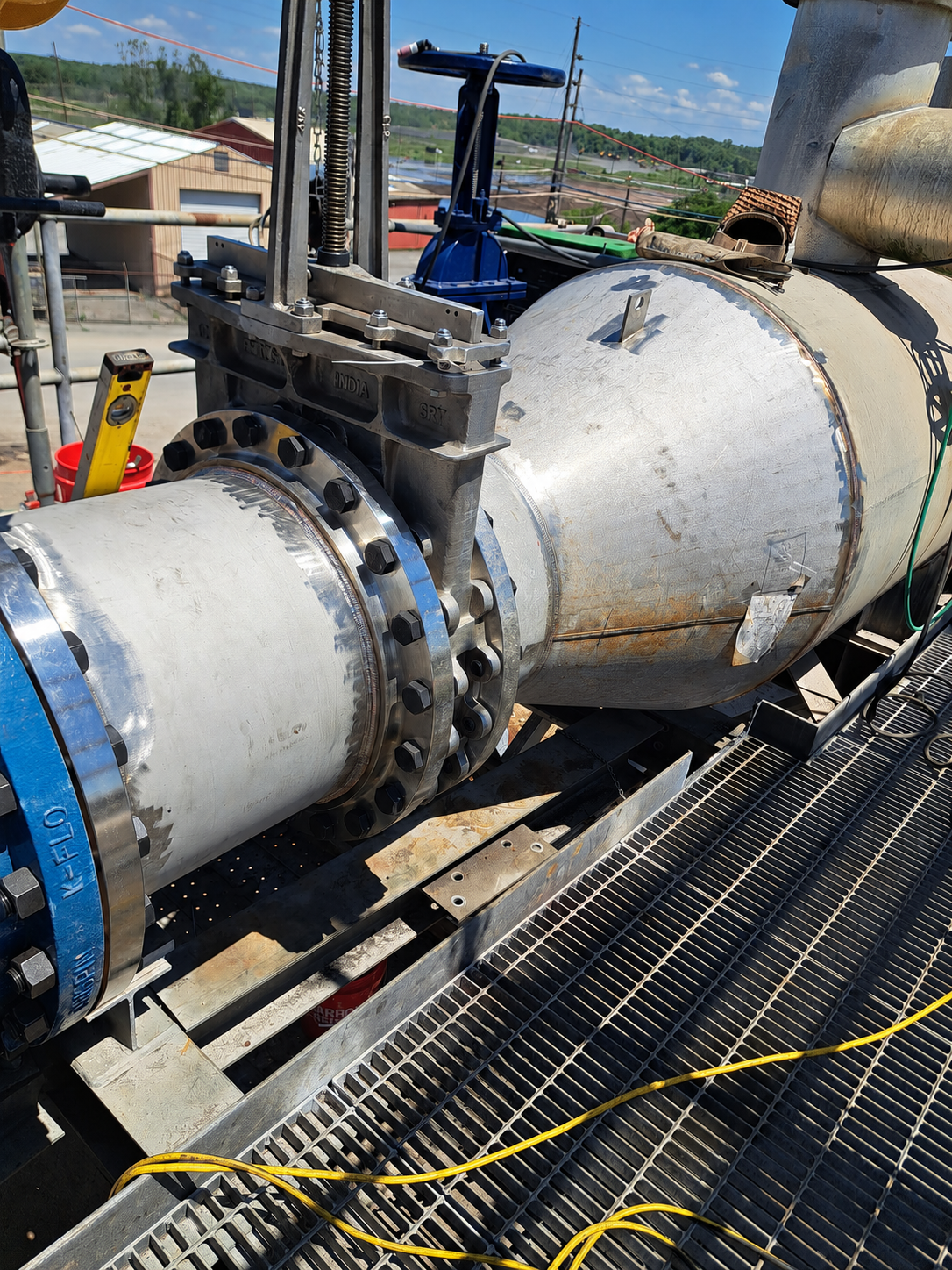 Melting Point LLC installed a heavy-duty industrial piping assembly with a knife gate valve and precision-welded pipe spool for the New Indy project.
