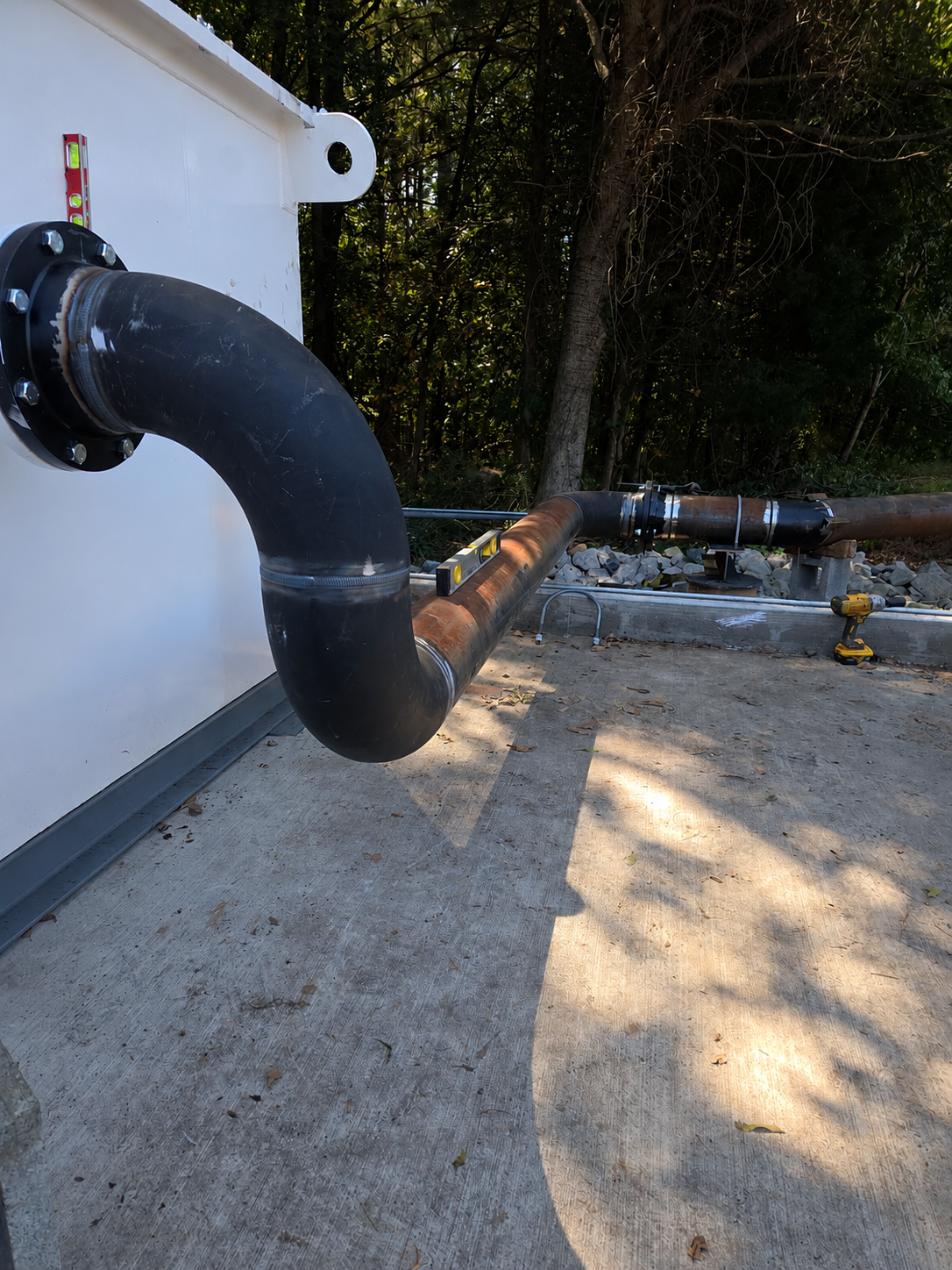Heavy industrial process piping staged for installation with crane support, highlighting welded pipe assemblies and mechanical field construction at the FOMAS project by Melting Point LLC in SC.