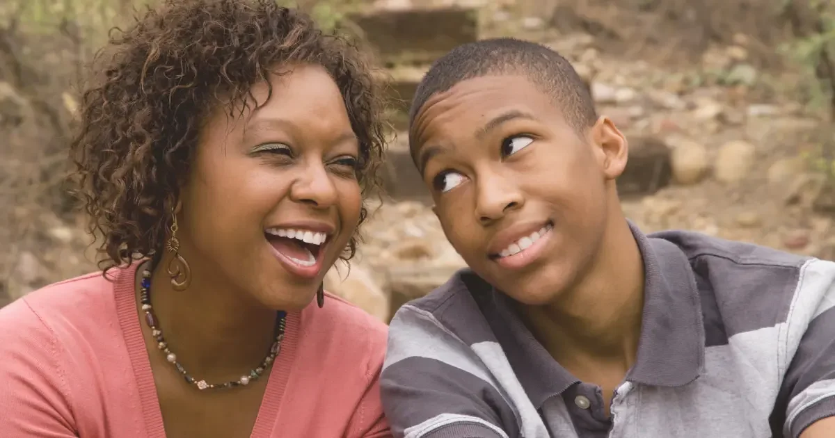 Mom receiving mental health treatment sitting with her son.