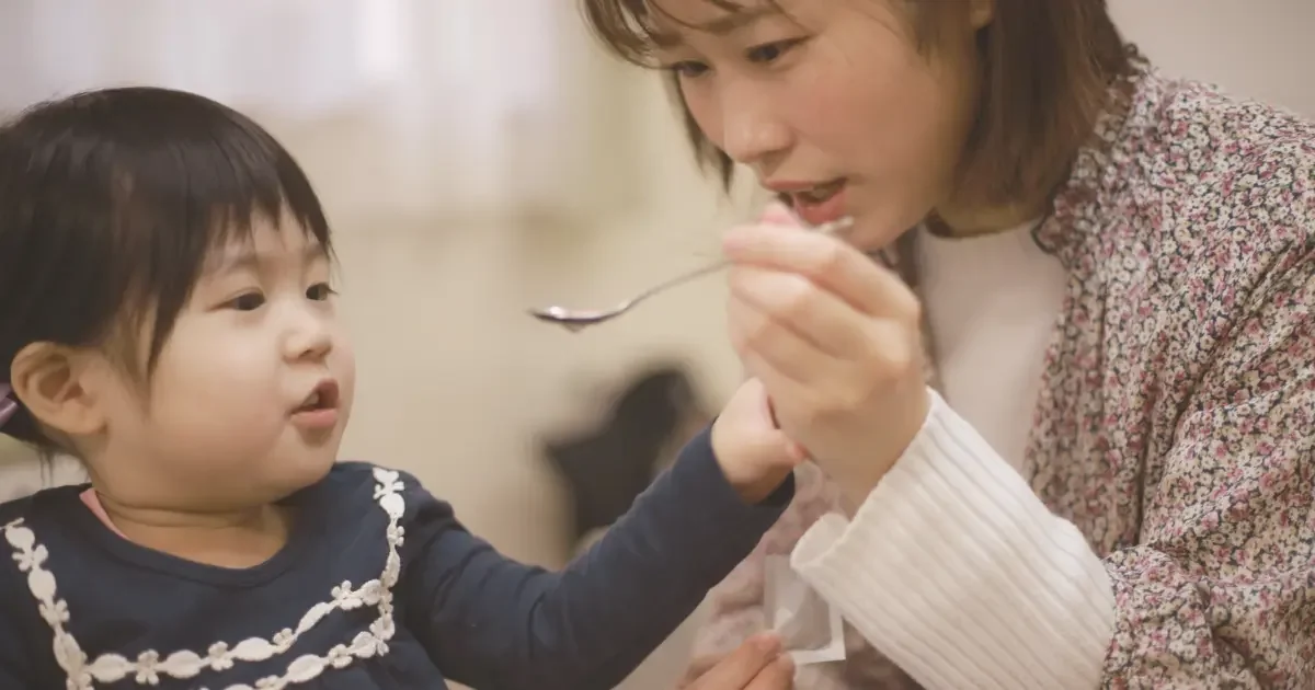Parent dealing with parental burnout and recovery feeding their child.