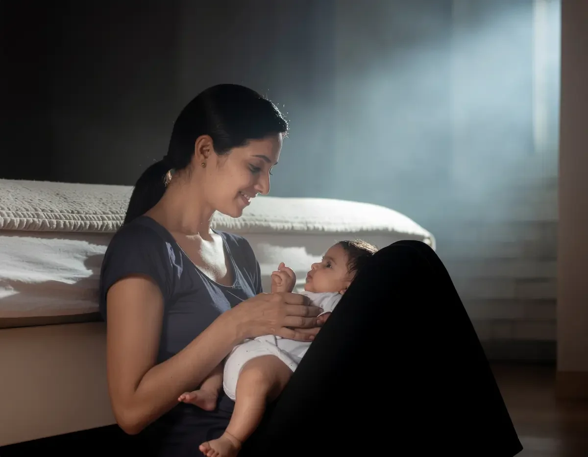 A postpartum mother breaking free from survival mode and smiling.