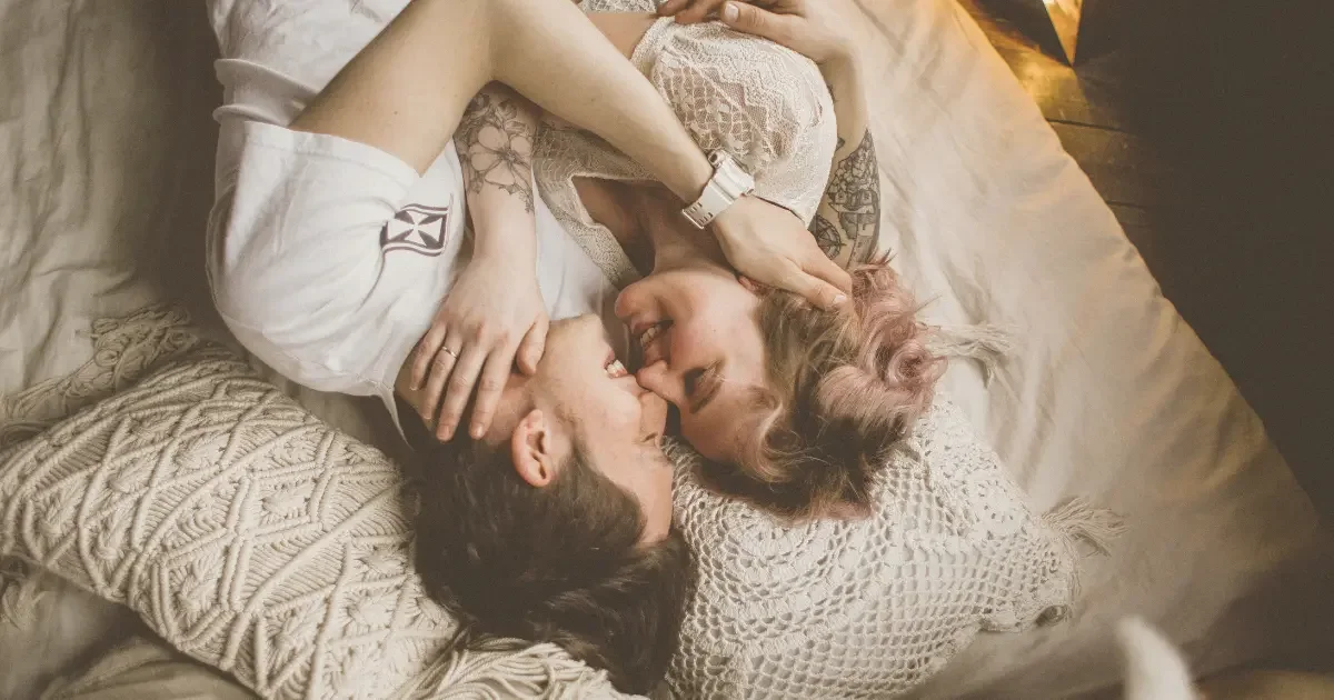 A couple cuddling in bed in a happy marriage.