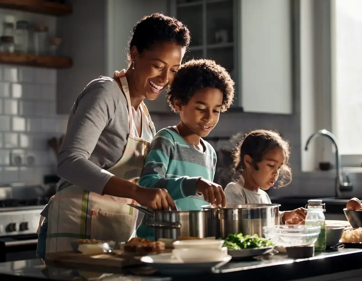 Mother cooking with kids in the kitchen to help build confident kids.
