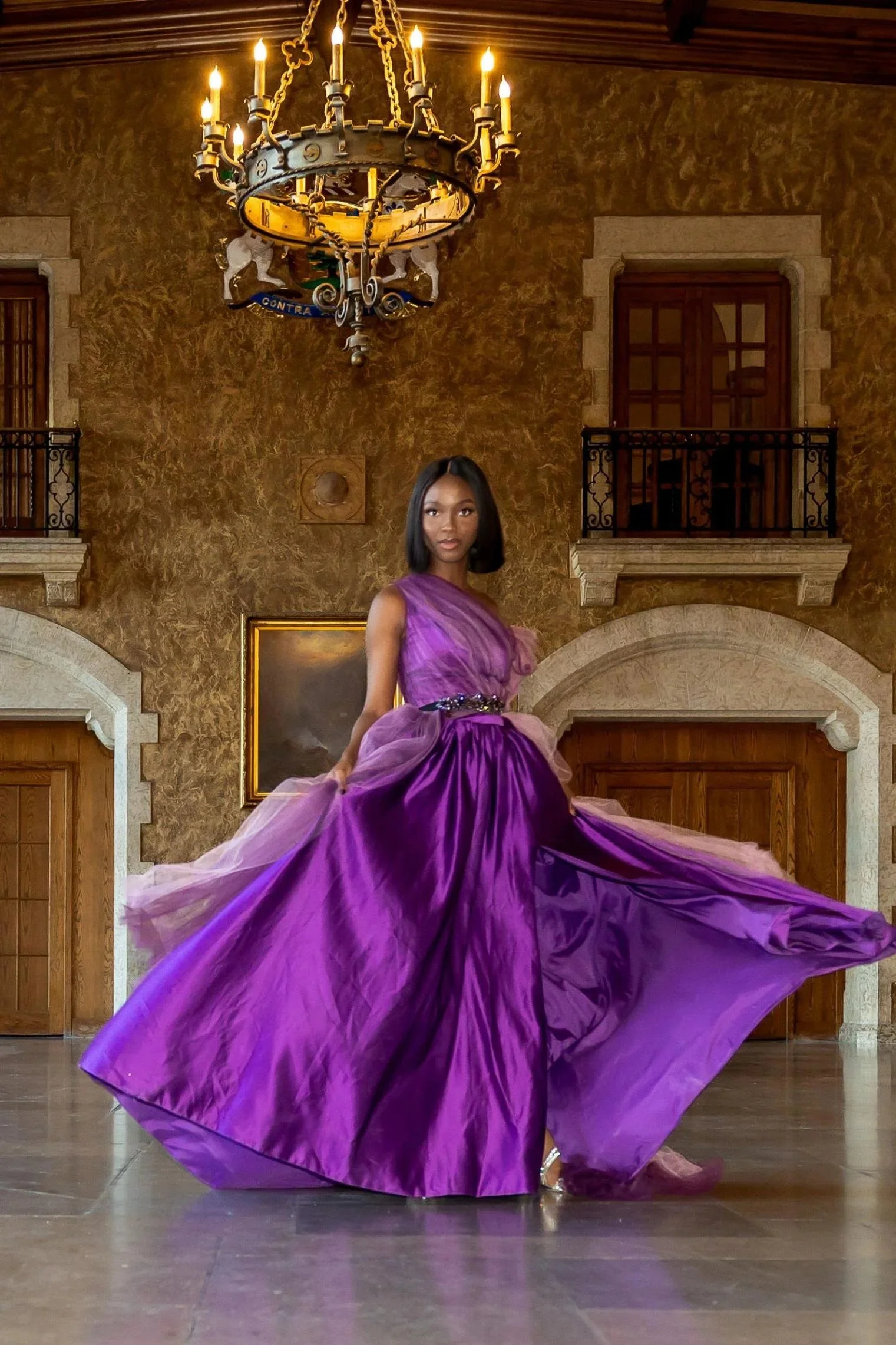 Woman wearing a purple satin dress with tulle tail and jewellery belt at Banff Hotel