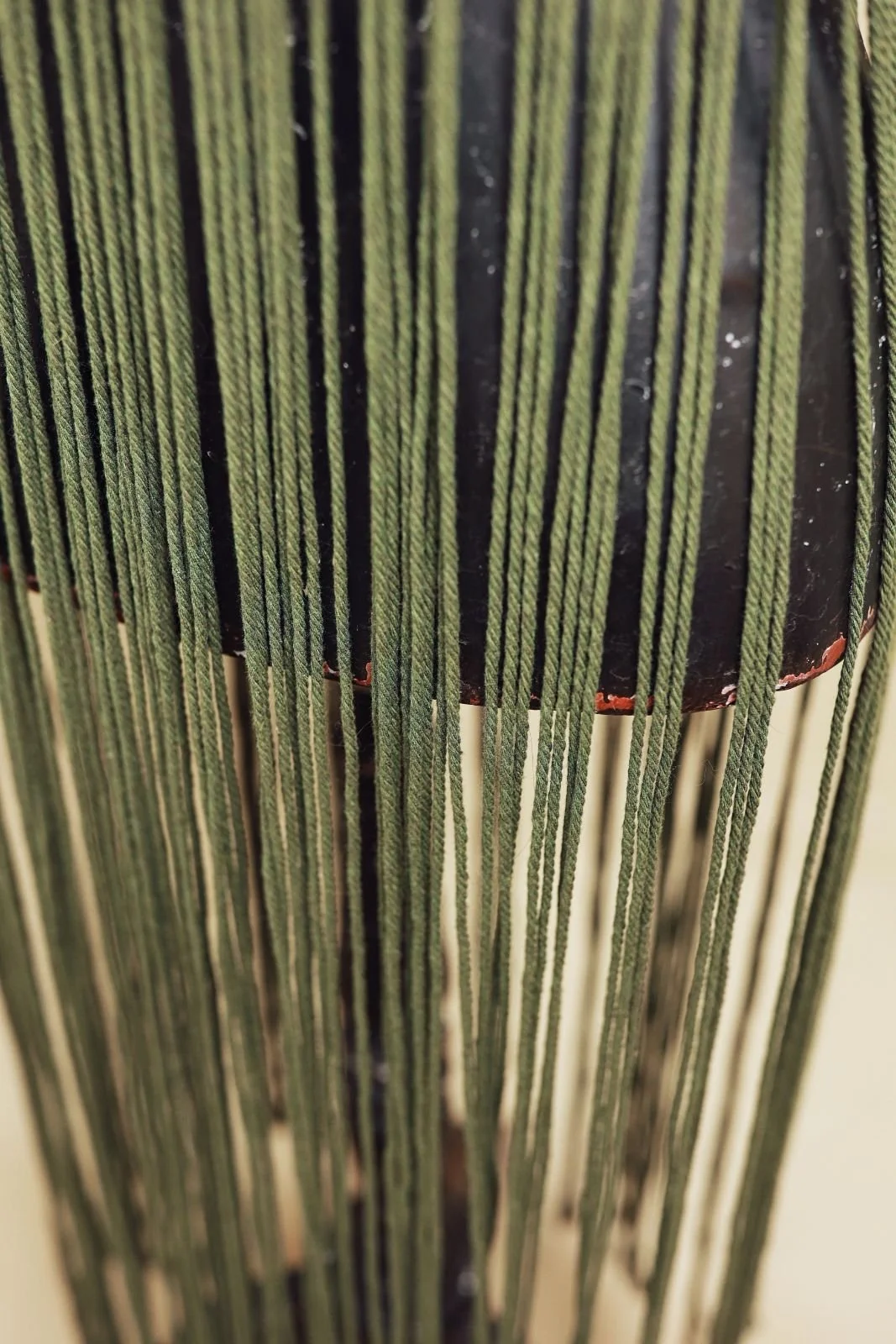 Close up of green macrame woven rope dress with floor length skirt