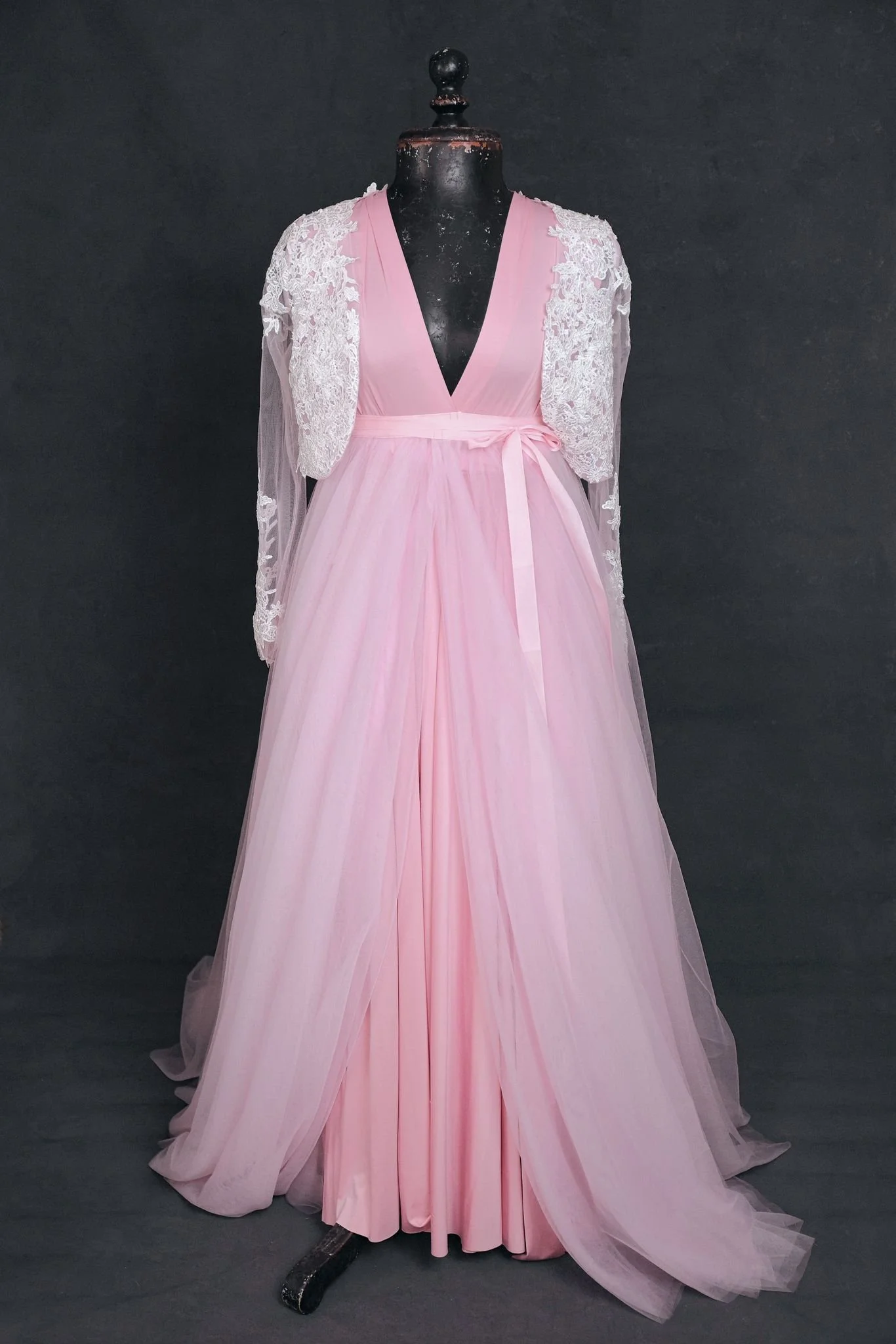 Pink infinity dress with a tulle skirt and white lace coat added overtop, tied with a pink ribbon at the waist