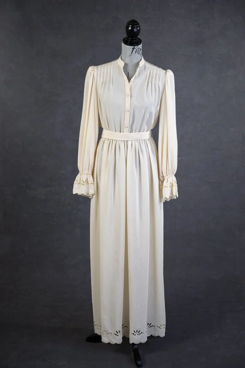 A full view of a vintage off-white dress with button-up upper, available for rent for engagement photoshoots in Calgary