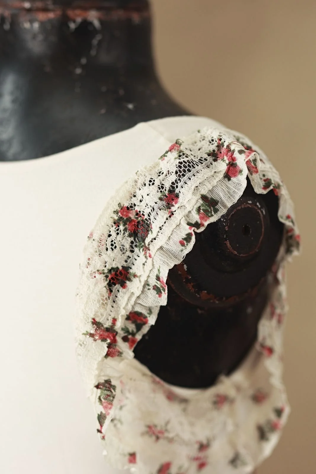 Close up showing white lace trim with floral print on shoulders