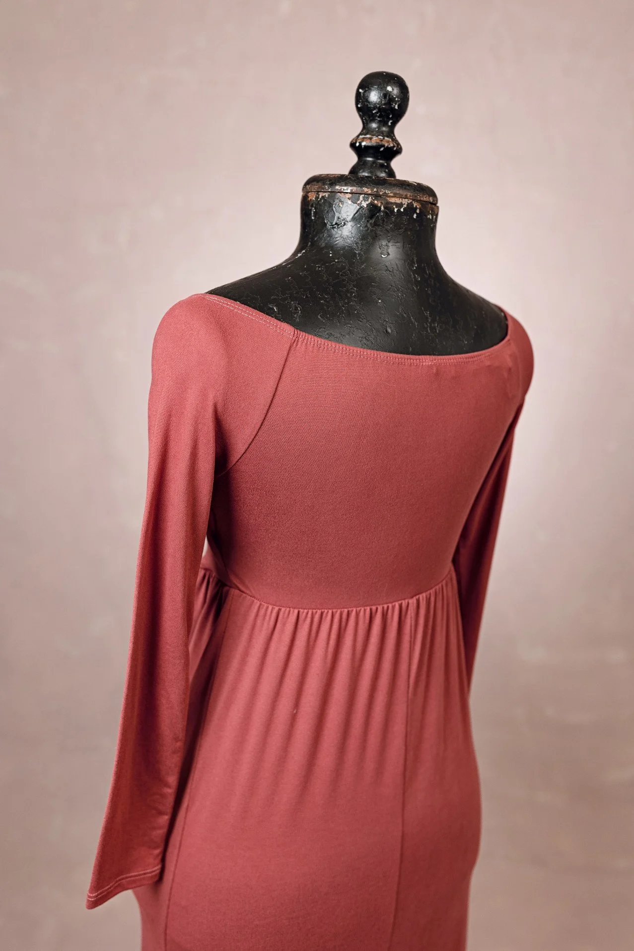 Back view of maroon red stretchy fabric dress showing scoop neckline