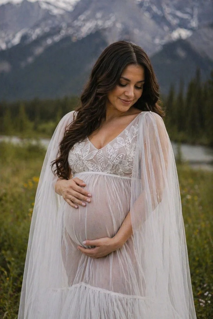 An AI generated image of a pregnant woman in the mountains of Alberta, wearing a white sheer lace gown with long sleeves and train for rent