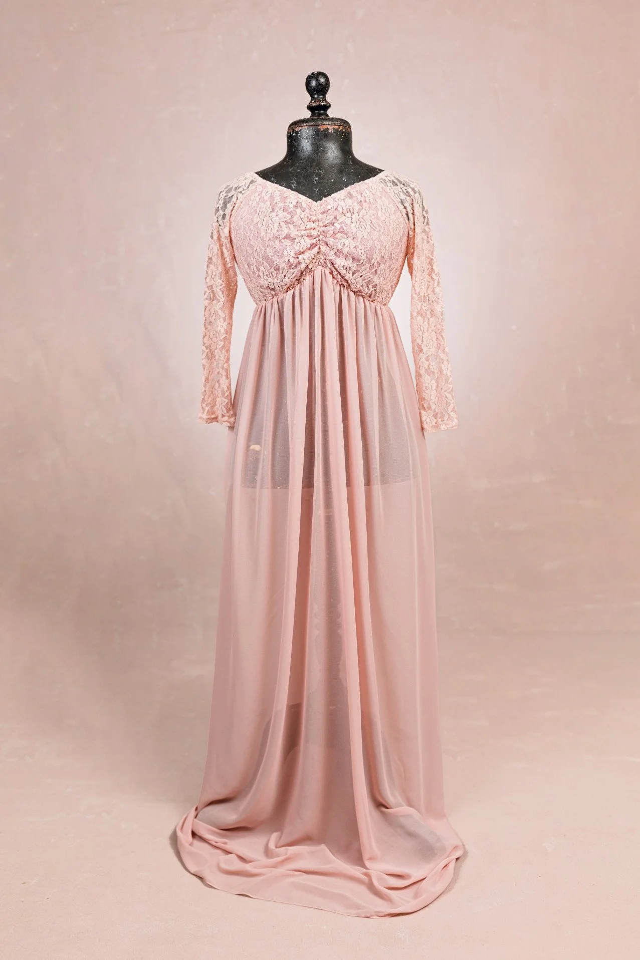 Peach pink maternity photoshoot rental dress with translucent floor-length skirt, and lace upper with long sleeves